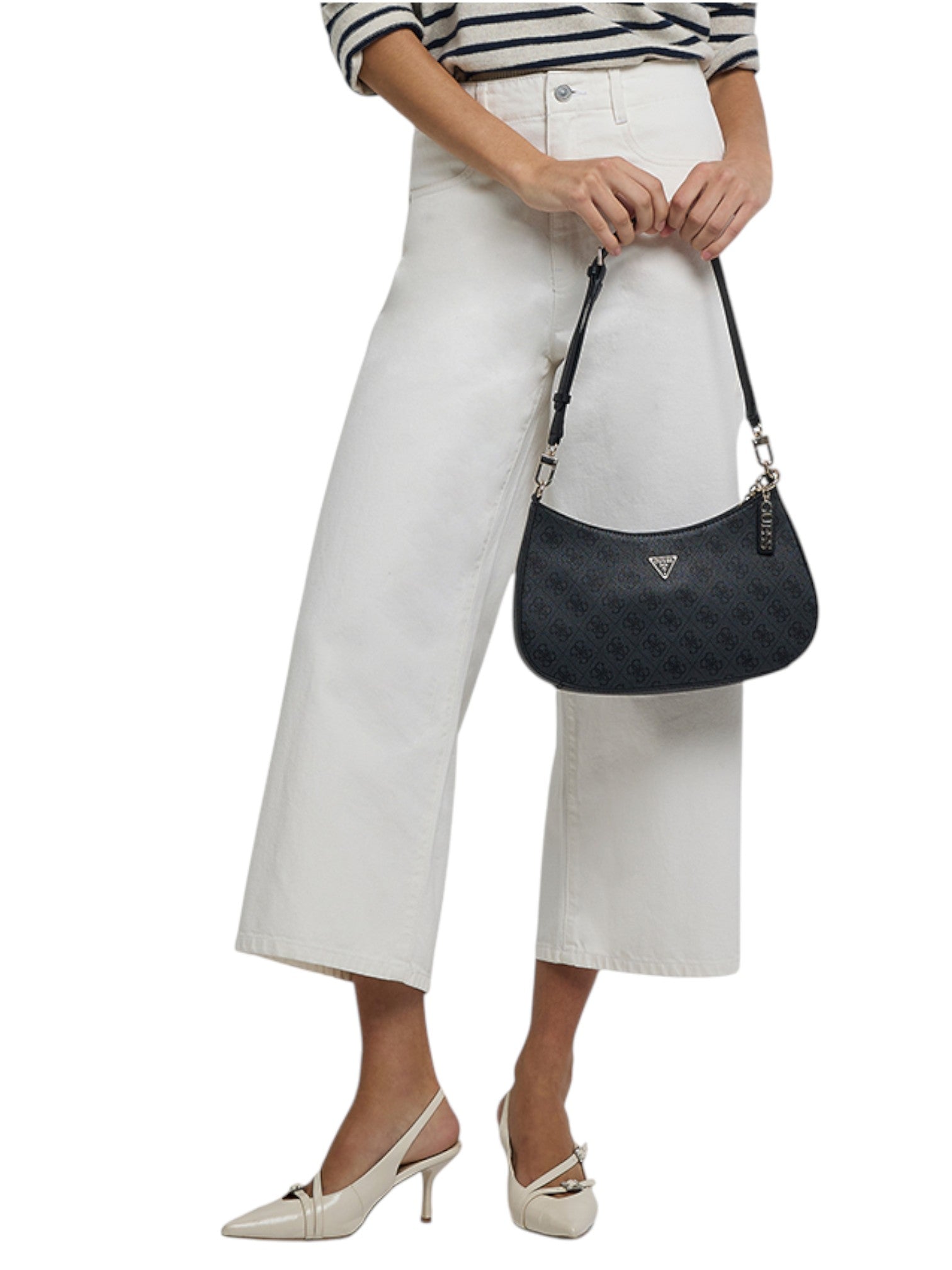 Person holding a black quilted handbag with a white background. Guess, Monza Outlet, Monza Fashion, Shein Outlet