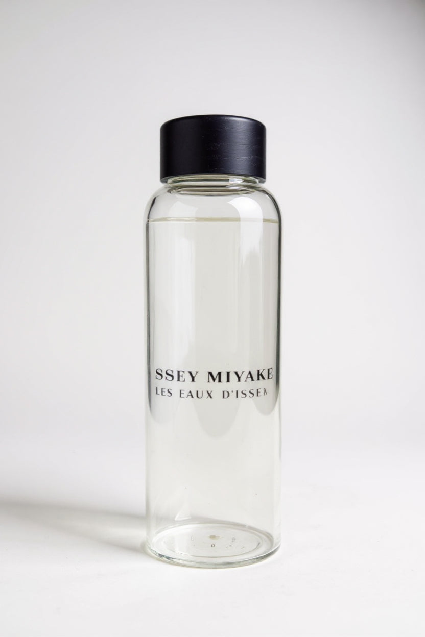 Clear bottle with black cap and 'Ssey Miyake branding on a white background. Issey Miyake, Monza Outlet, Monza Fashion, Shein Outlet