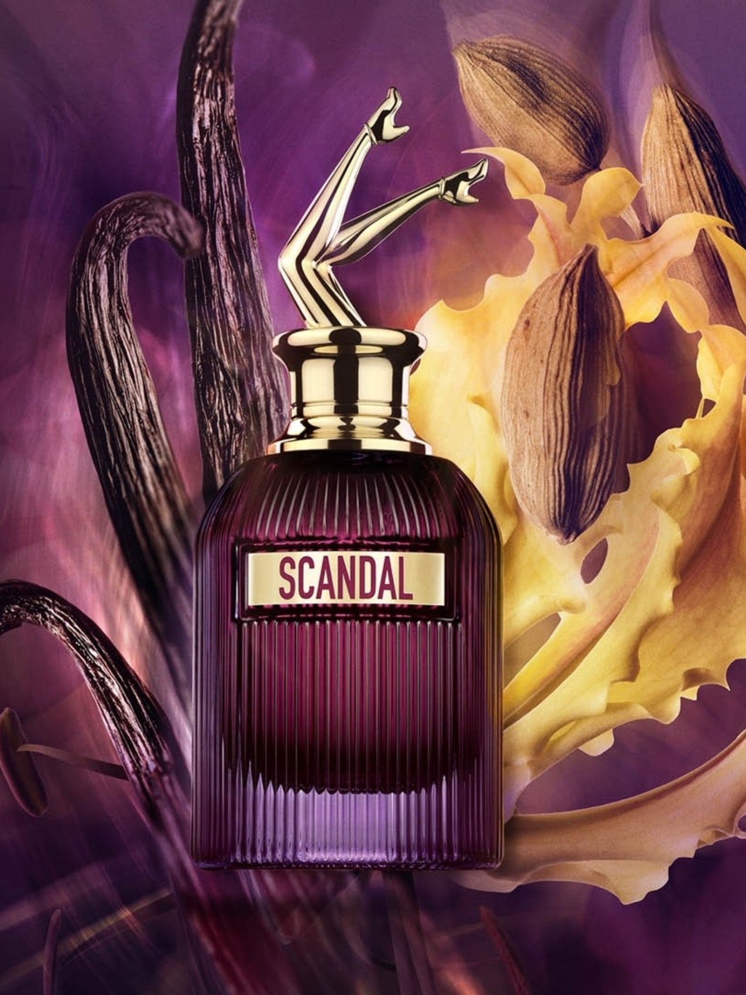 Scandal perfume bottle with gold cap on a purple and yellow floral background. Jean Paul Gaultier, Monza Outlet, Monza Fashion, Shein Outlet