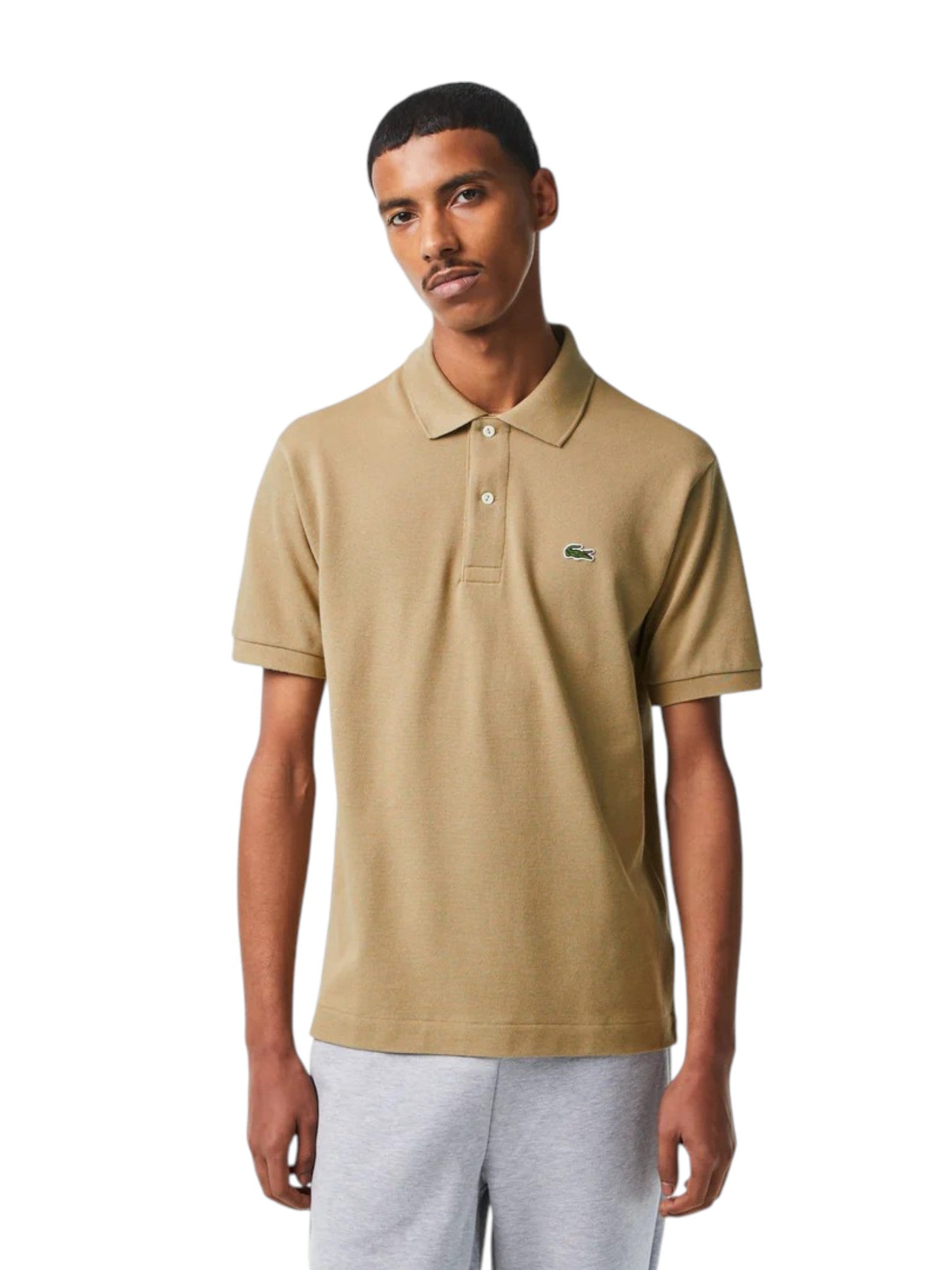 Man wearing a beige polo shirt on a white background. Lacoste, Monza Outlet, Monza Fashion, Shein Outlet