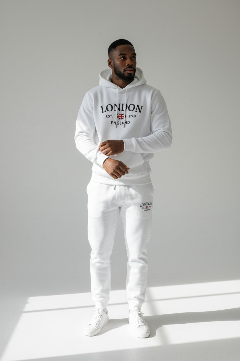 Man wearing a white hoodie and pants with London England text on a light gray background. Antler, Monza Outlet, Monza Fashion, Shein Outlet
