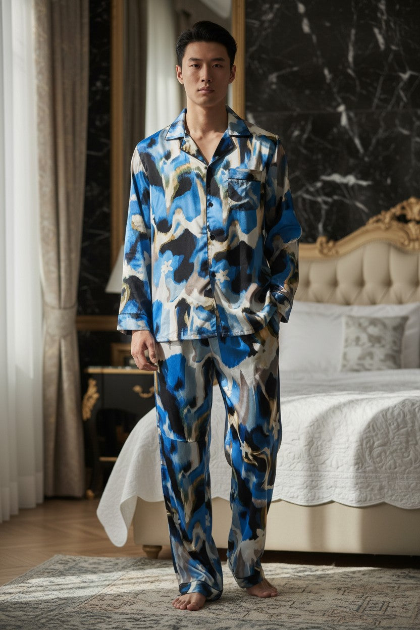 Man wearing a blue and black patterned pajama set in a bedroom. Monza Italy, Monza Outlet, Monza Fashion, Shein Outlet