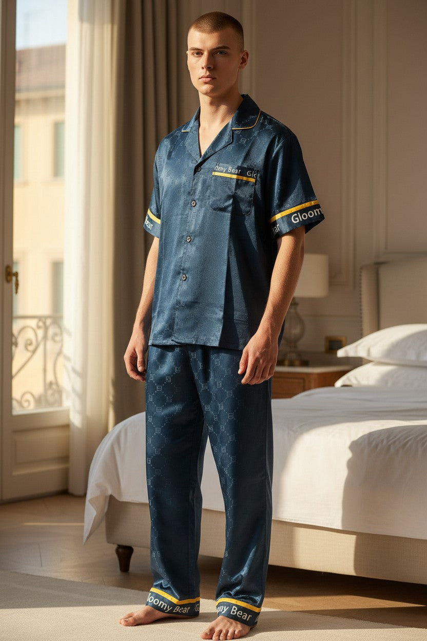 Man wearing blue pajamas with 'Goodnight' branding in a bedroom setting. Monza Italy, Monza Outlet, Monza Fashion, Shein Outlet