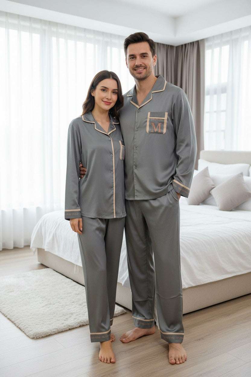 Man and woman wearing matching gray pajamas in a bedroom. Monza Italy, Monza Outlet, Monza Fashion, Shein Outlet