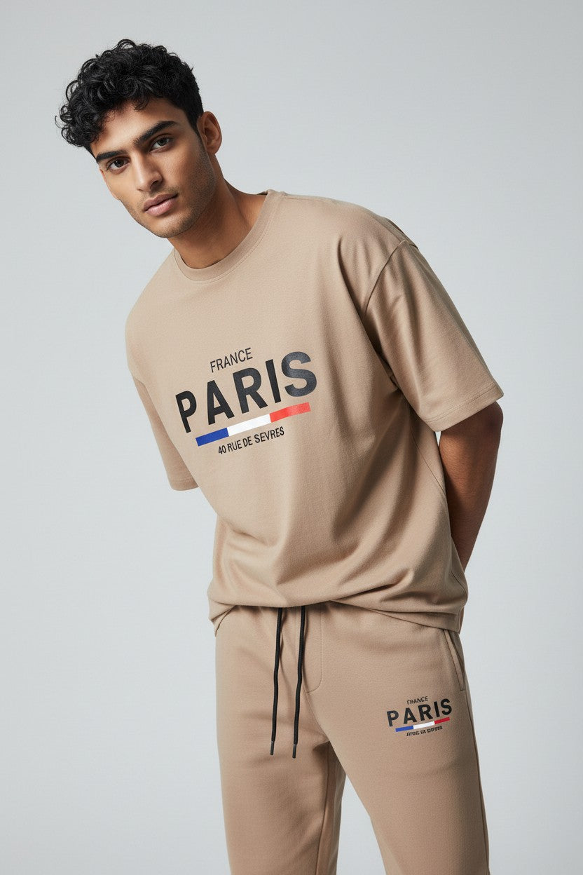 Man wearing a beige Paris sweatshirt and pants on a white background. Antler, Monza Outlet, Monza Fashion, Shein Outlet