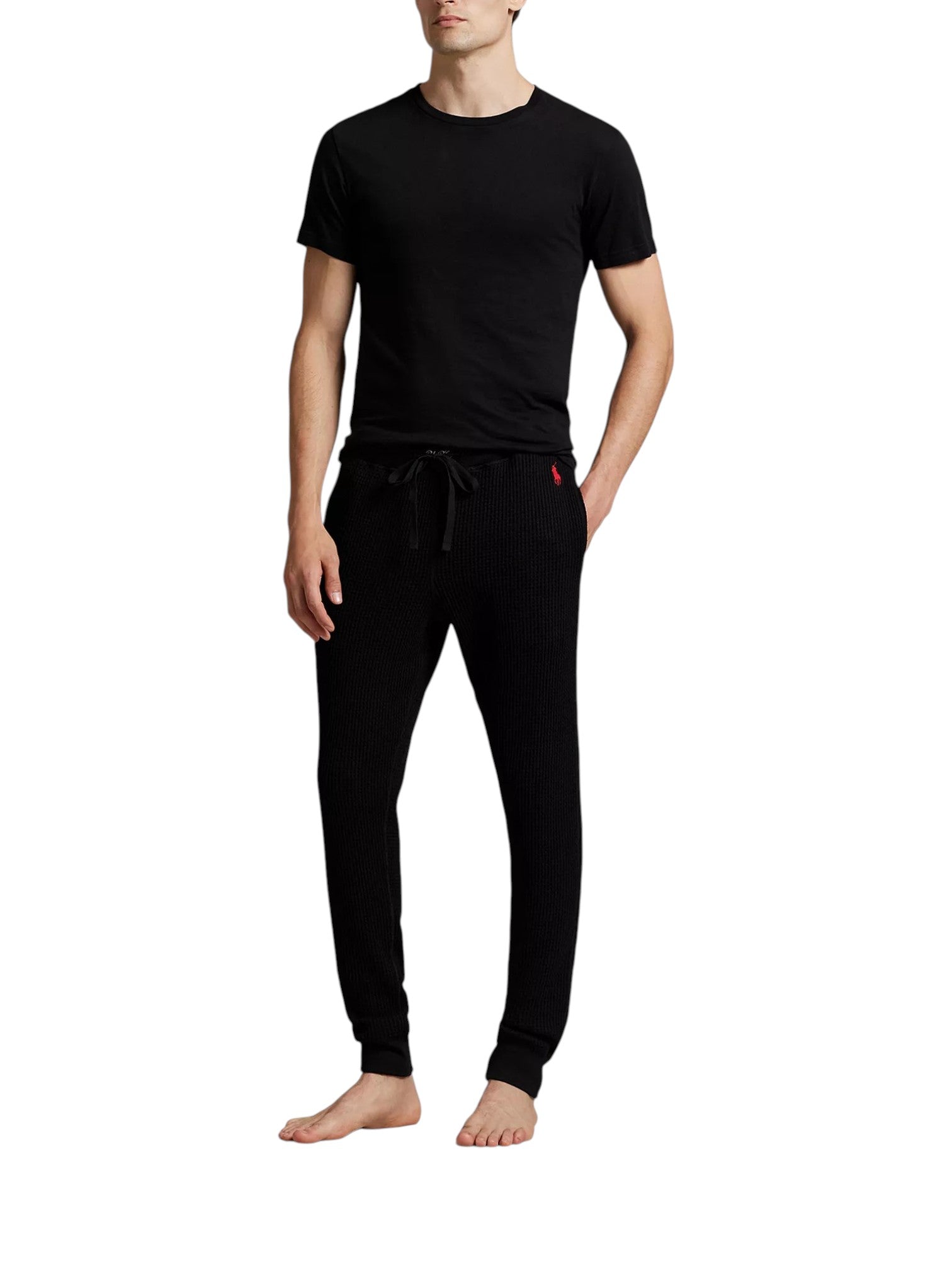 Person wearing a black t-shirt and black pants on a white background. Polo Ralph Lauren, Monza Outlet, Monza Fashion, Shein Outlet
