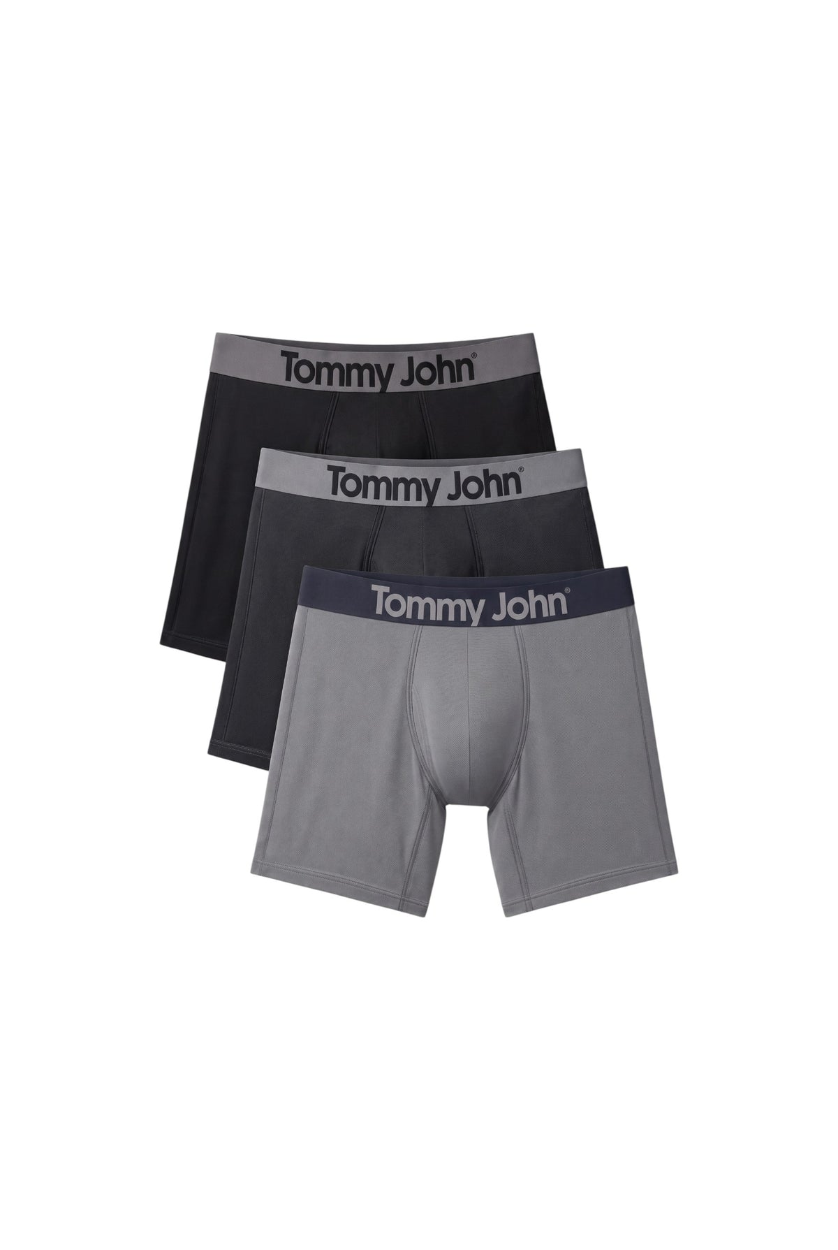 Three pairs of Tommy John men's boxer briefs stacked in a fan arrangement on a plain white background. The colors are black, dark gray, and light gray, with the brand name Tommy John printed on the waistbands. Tommy Hilfiger, Monza Outlet, Monza Fashion, Shein Outlet