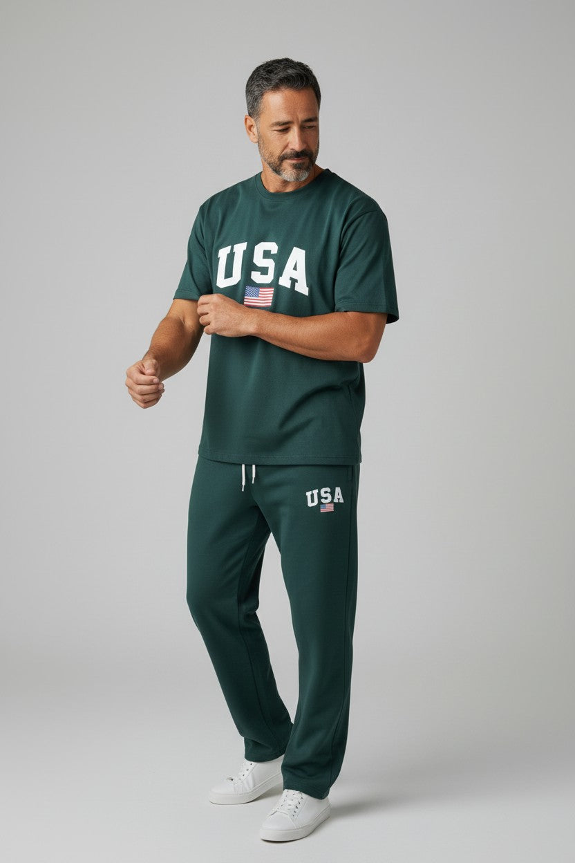 Man wearing a green USA t-shirt and pants on a gray background. Antler, Monza Outlet, Monza Fashion, Shein Outlet