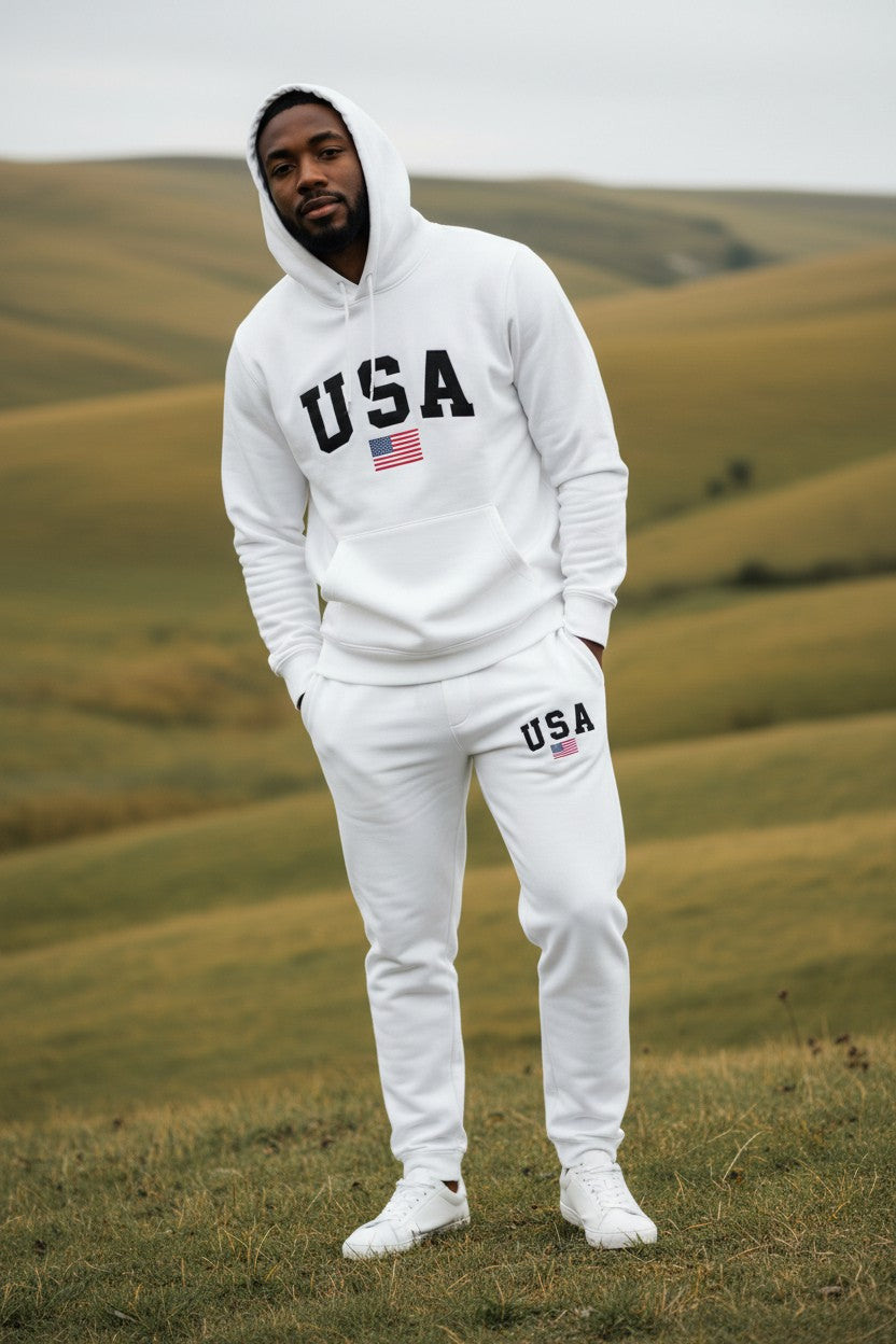 Person wearing a white USA hoodie and pants standing in a field. Antler, Monza Outlet, Monza Fashion, Shein Outlet
