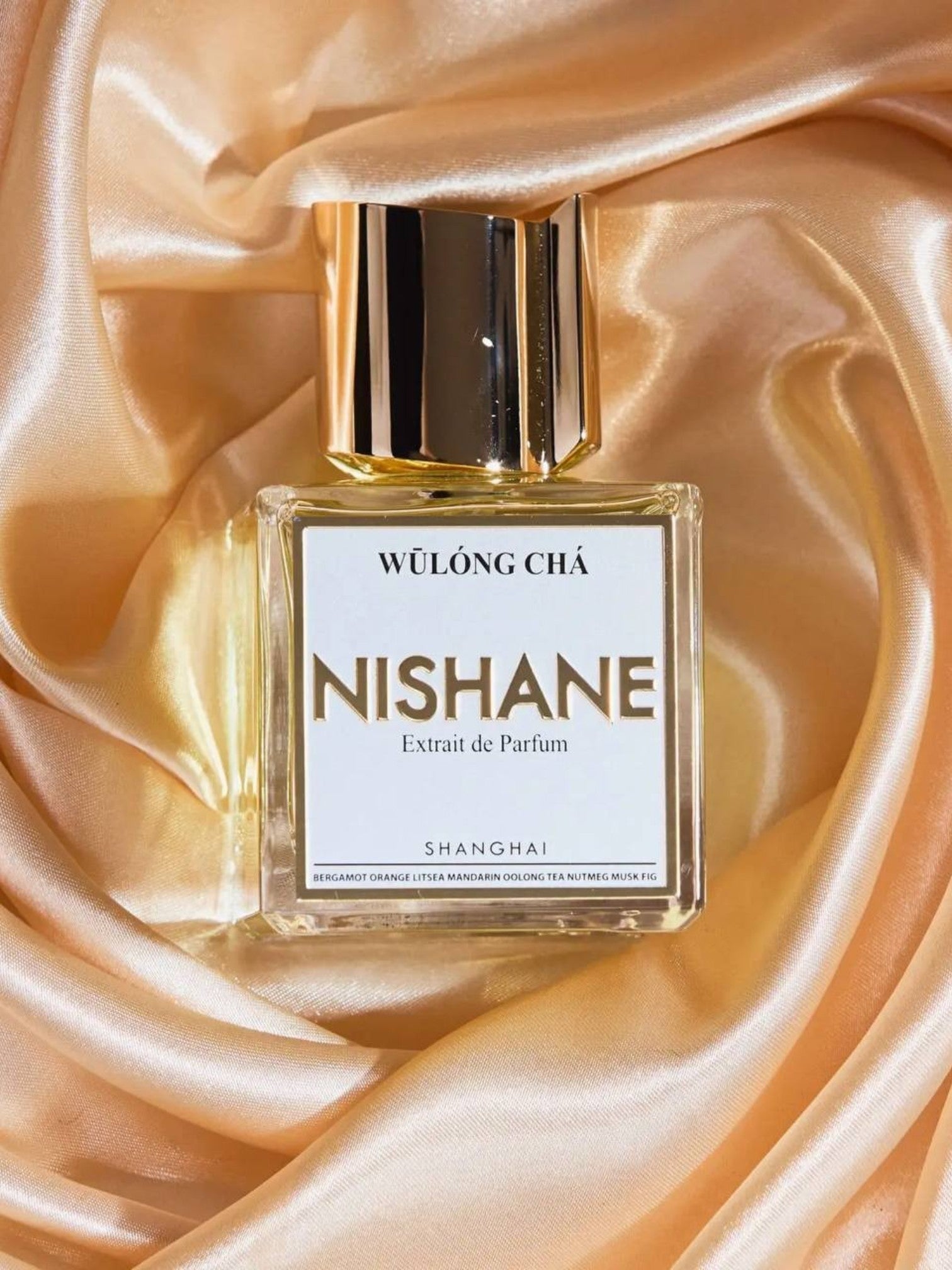 Nishane perfume bottle on a satin background. Nishane, Monza Outlet, Monza Fashion, Shein Outlet