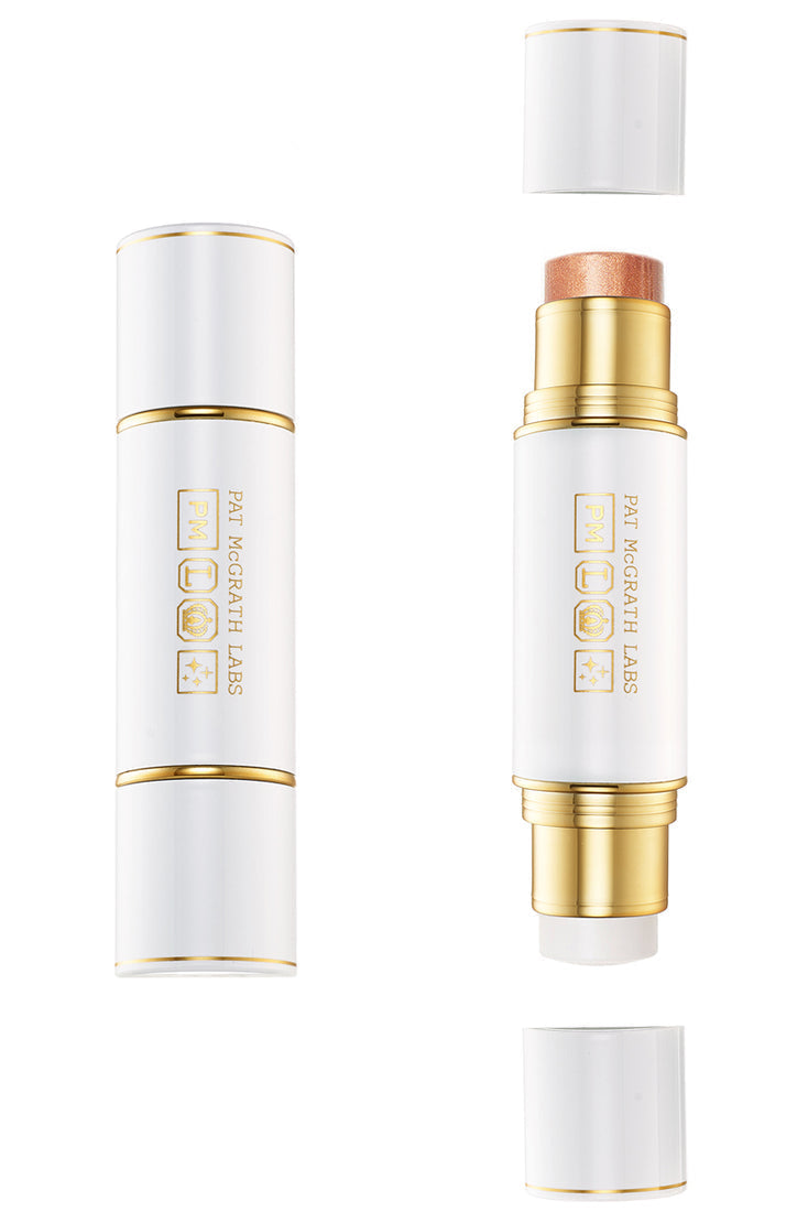 Two-stick cosmetic product packaging, one with a copper-colored highlighter and the other with a clear balm, both with PAT McGRATH LABS branding. Monza Outlet
