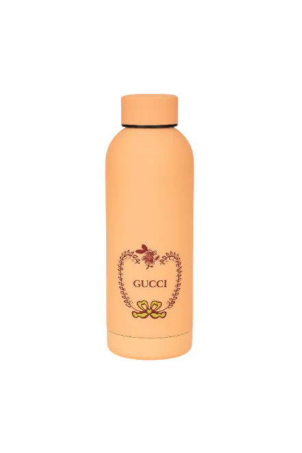 Peach-colored Gucci water bottle with decorative elements on a white background Monza Outlet