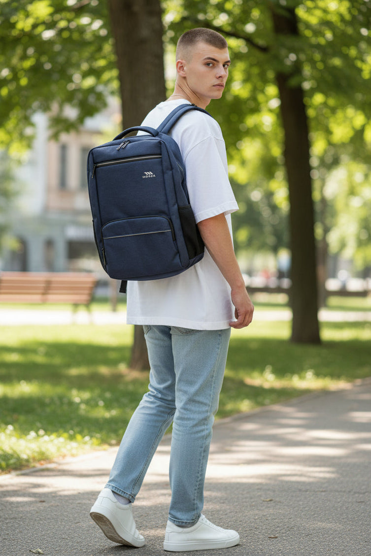 Person walking outdoors with a navy blue backpack. Monza Italy, Monza Outlet, Monza Fashion, Shein Outlet