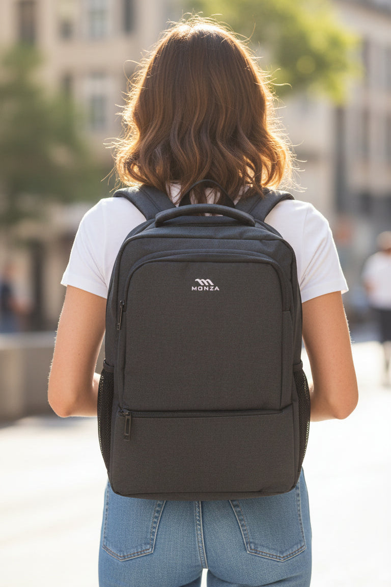 Person wearing a black backpack with a blurred city street background. Monza Italy, Monza Outlet, Monza Fashion, Shein Outlet