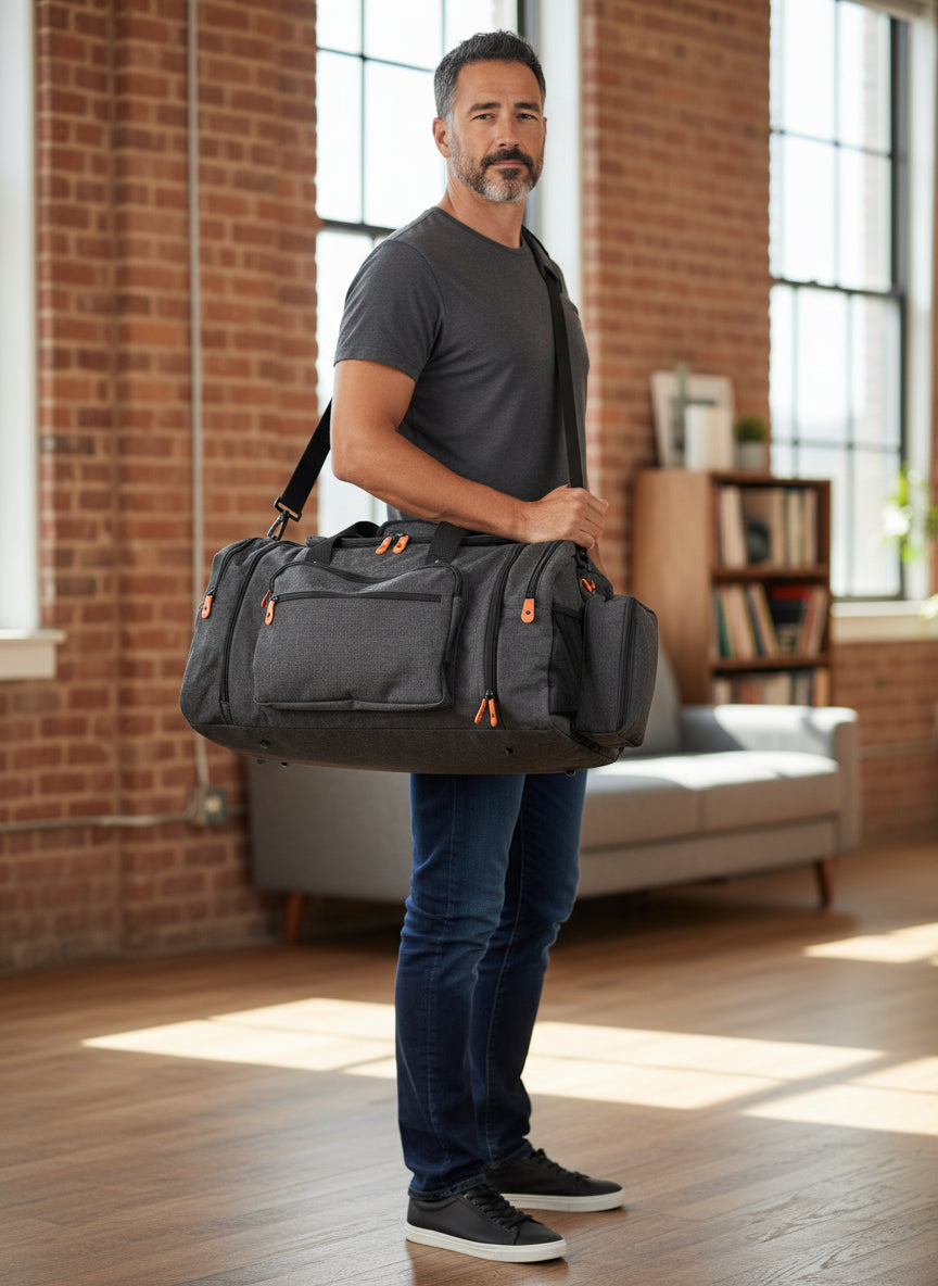 Man holding a gray duffel bag in a room with brick walls and large windows. Monza Italy, Monza Outlet, Monza Fashion, Shein Outlet