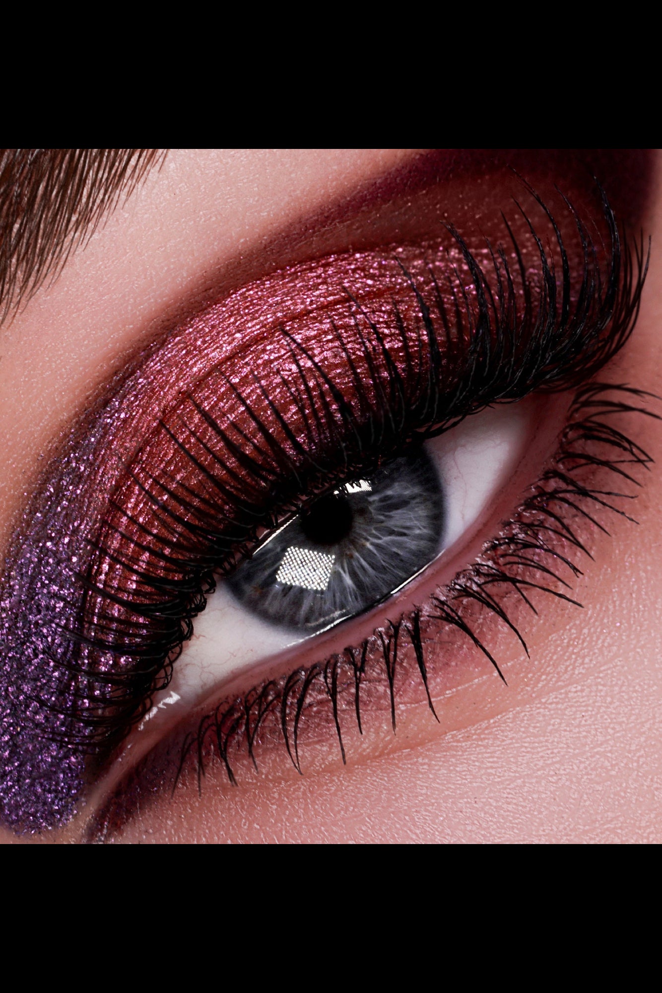Close-up of an eye with glittery eyeliner and false eyelashes. Monza Outlet