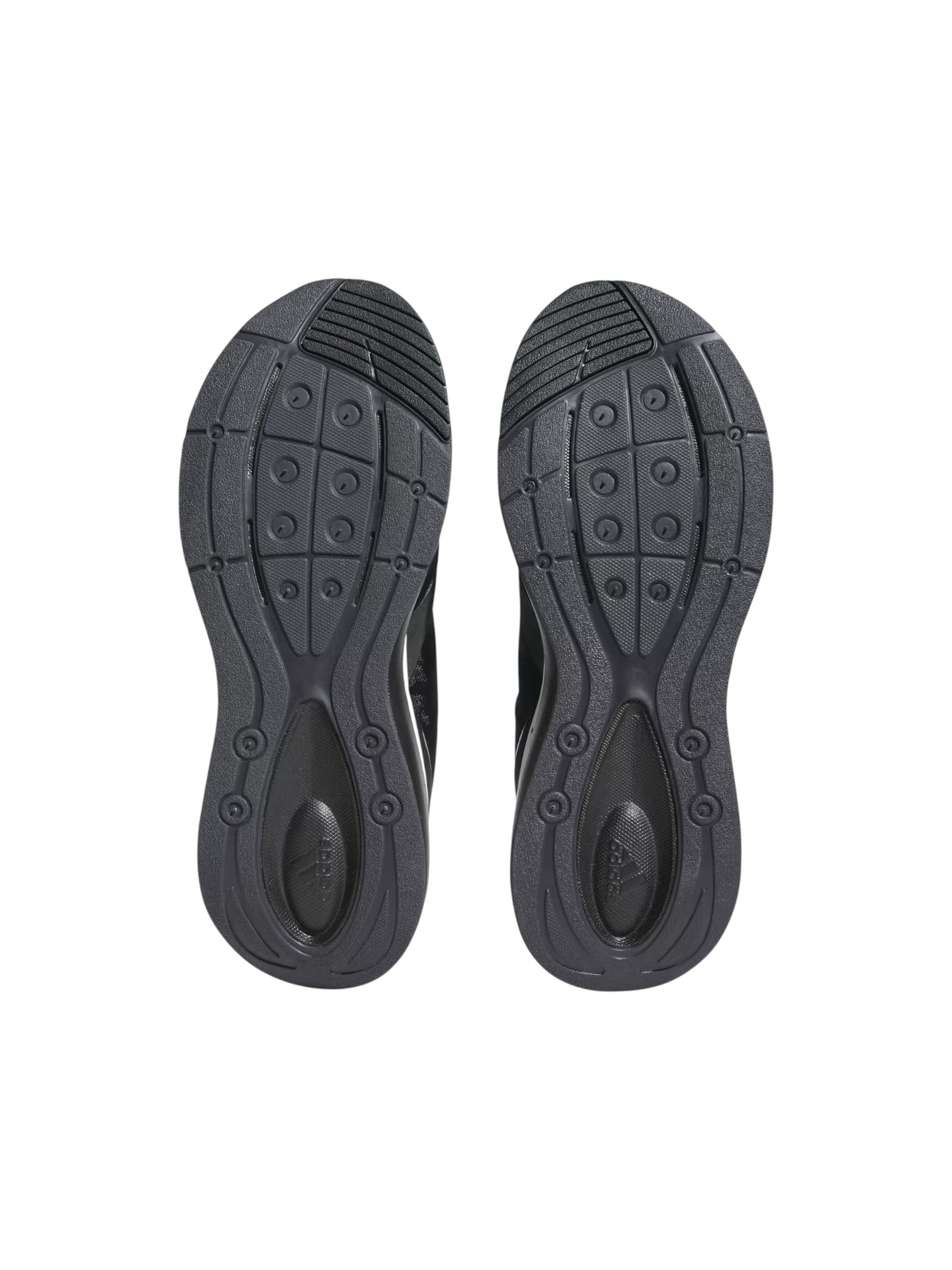 Black shoe soles with tread pattern on a white background. Adidas, Monza Outlet, Monza Fashion, Shein Outlet