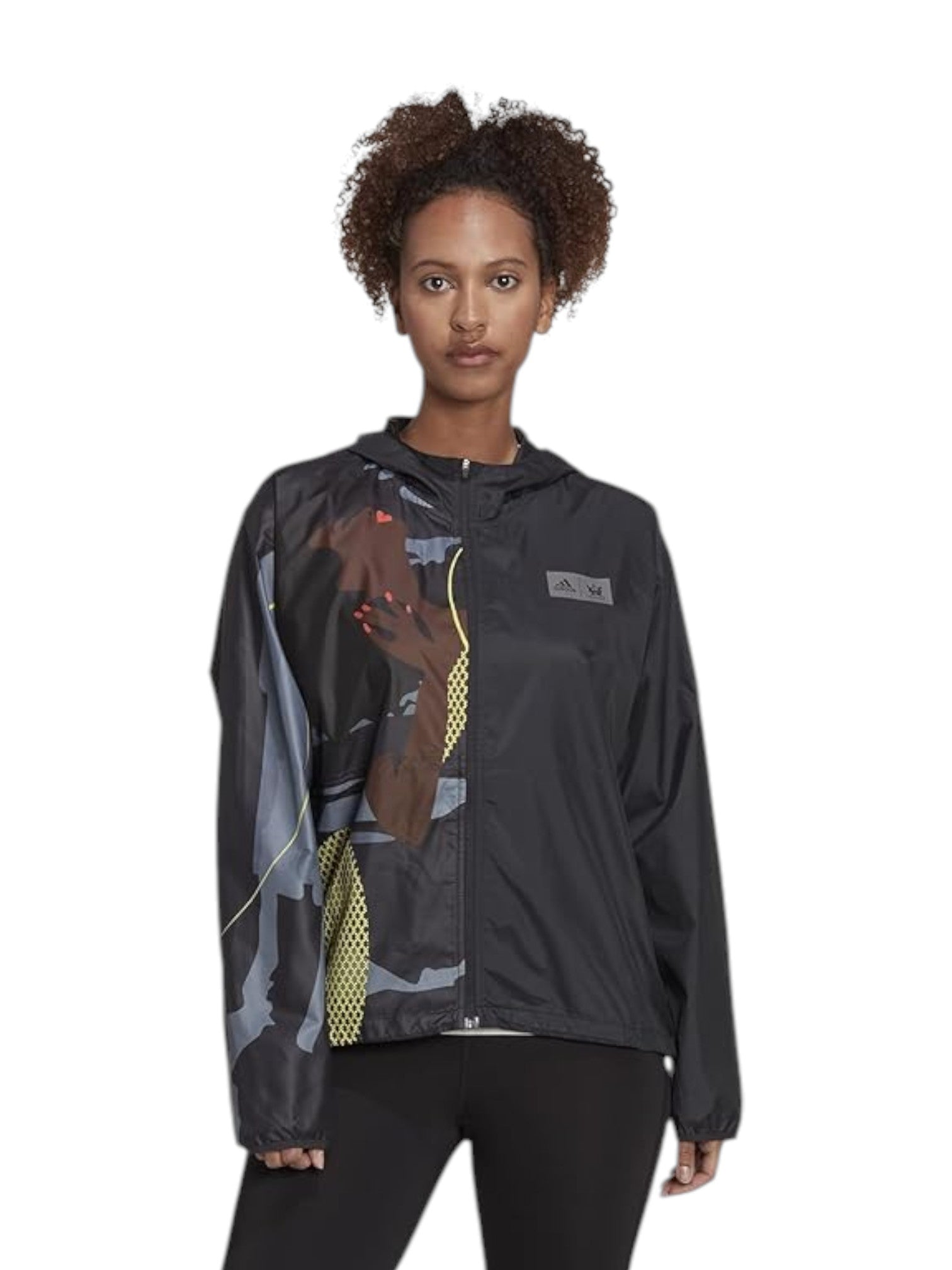 Person wearing a black jacket with colorful design on a white background. Adidas, Monza Outlet, Monza Fashion, Shein Outlet