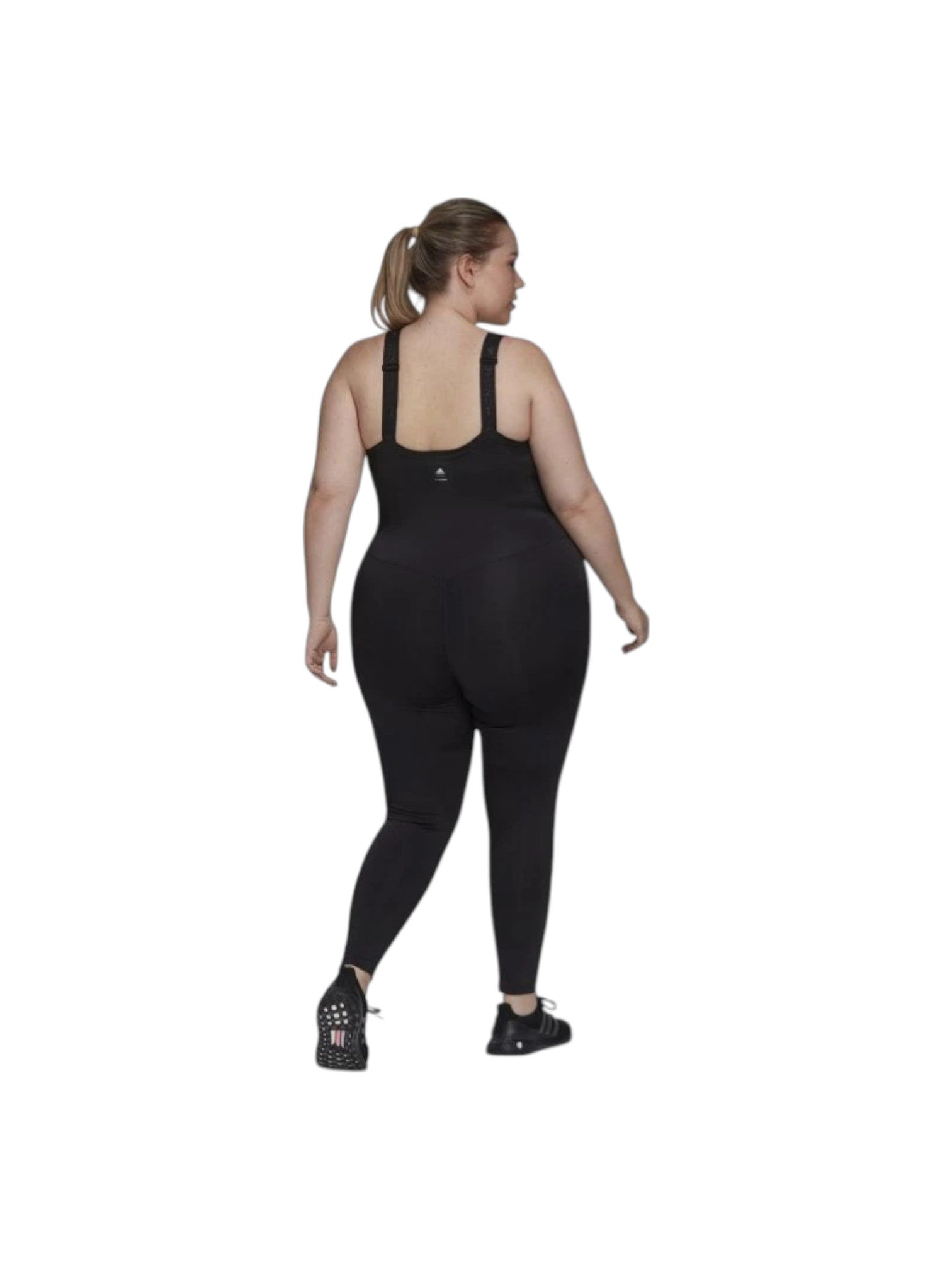 Person wearing a black jumpsuit on a white background. Adidas, Monza Outlet, Monza Fashion, Shein Outlet