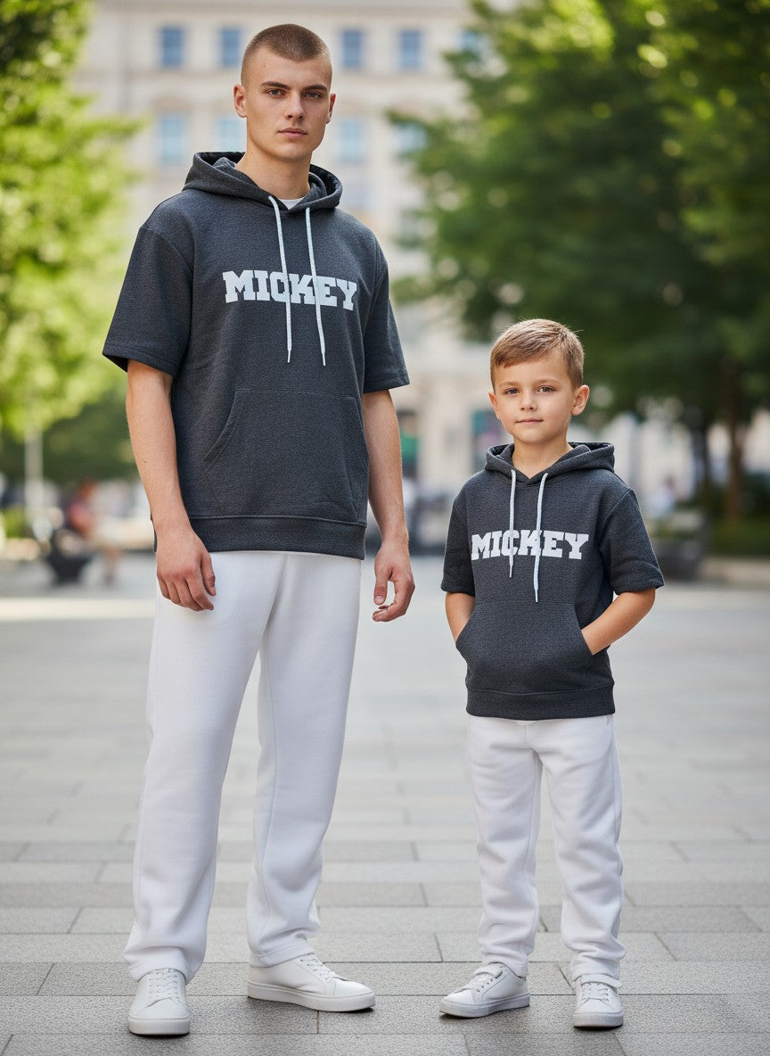 Two individuals wearing matching 'MICKEY' hoodies on a city street. Antler, Monza Outlet, Monza Fashion, Shein Outlet 