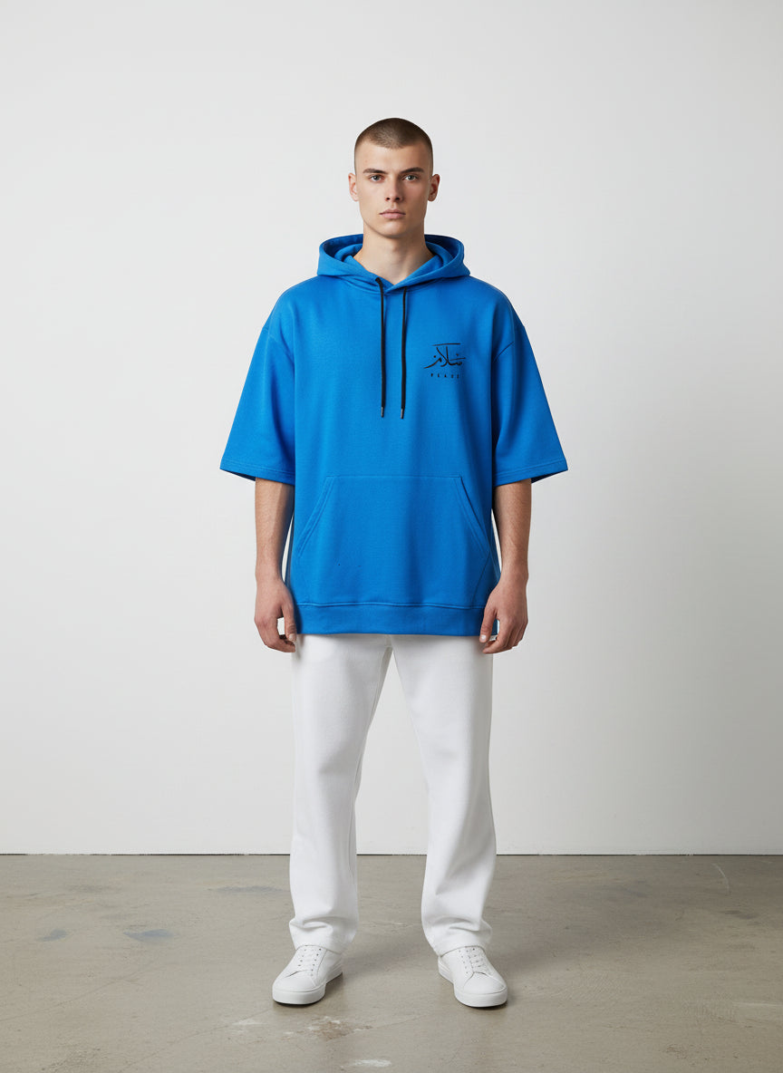 Person wearing a blue hoodie with a logo on a white background. Antler, Monza Outlet, Monza Fashion, Shein Outlet  