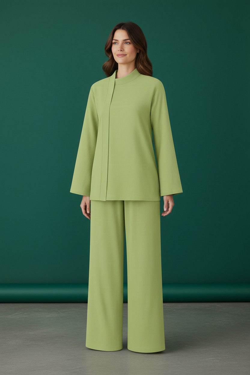 Woman wearing a green suit against a green background. Antler, Monza Outlet, Monza Fashion, Shein Outlet