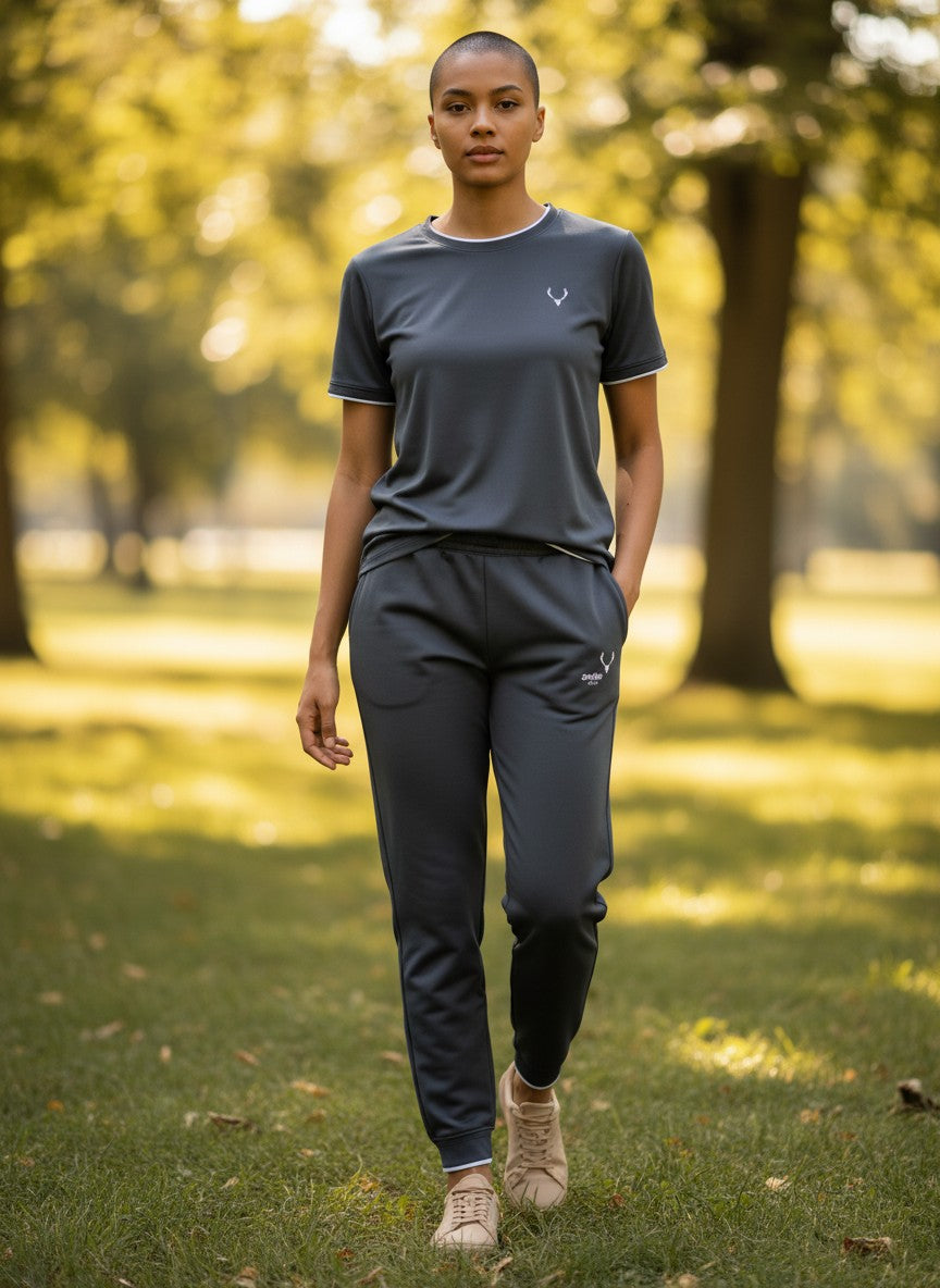 Person wearing a dark gray athletic outfit standing in a park. Antler, Monza Outlet, Monza Fashion, Shein Outlet 