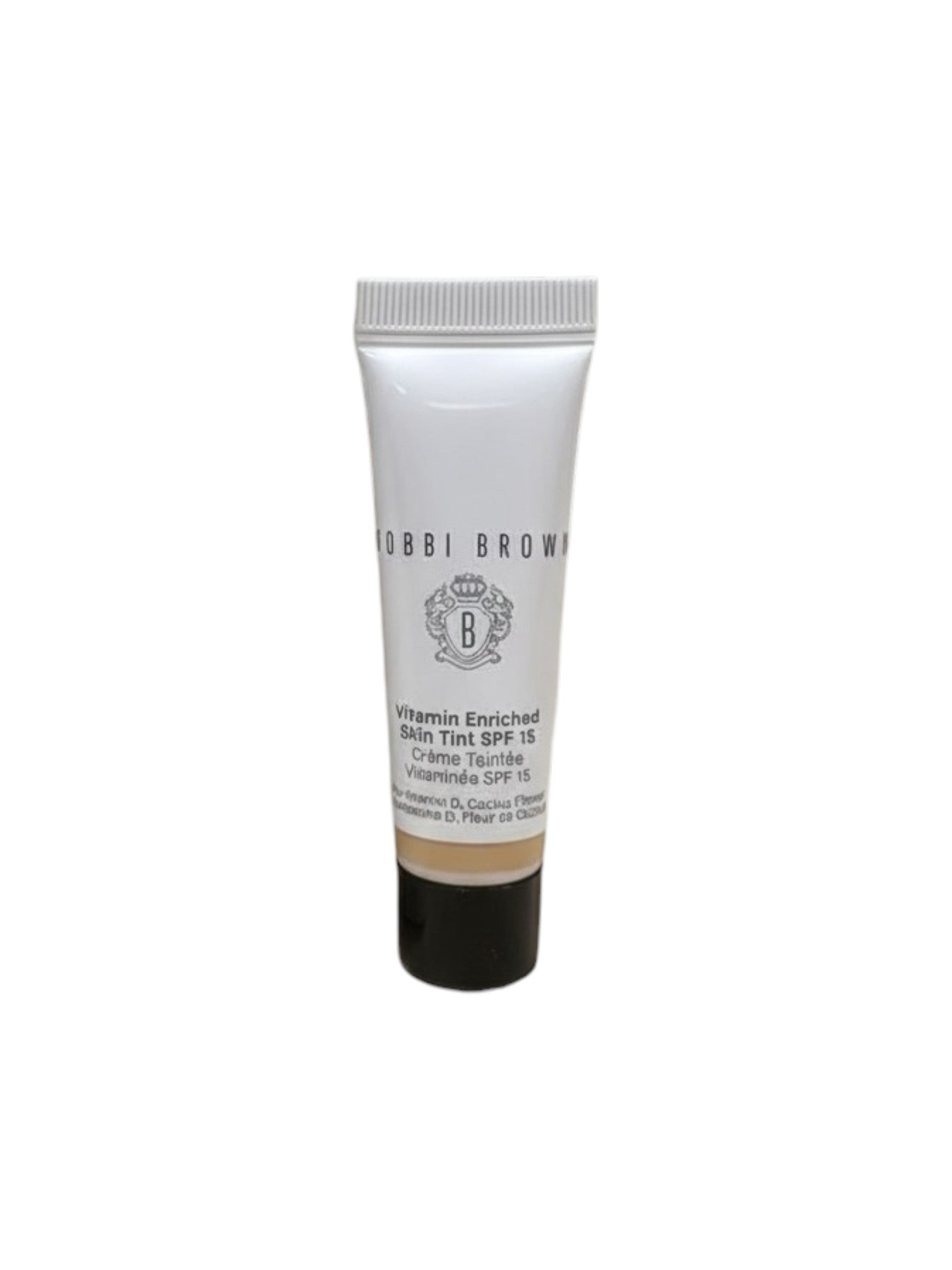 Woman applying cream to her face with a skincare product on a counter. Bobbi Brown, Monza Outlet, Monza Fashion, Shein Outlet