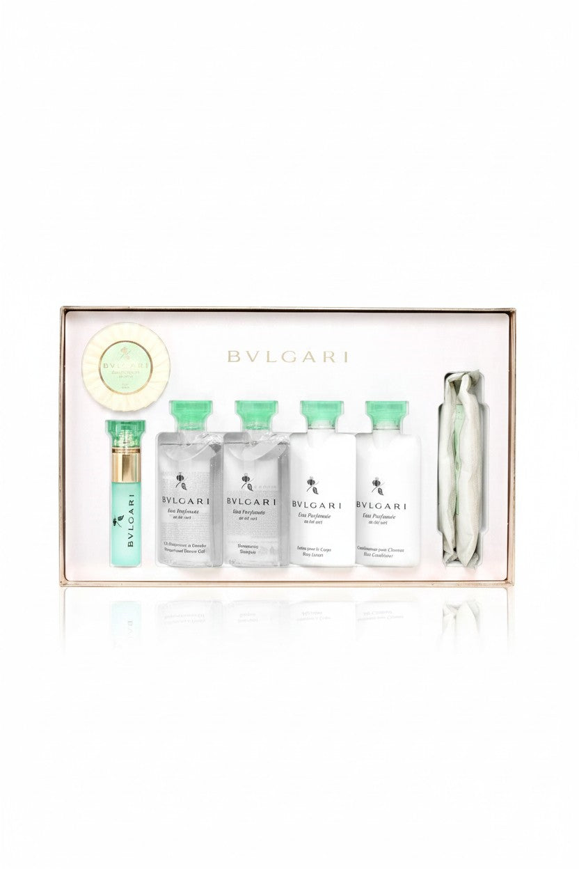Bvlgari toiletry gift set in a rectangular box, featuring five small white bottles with mint green caps, a mint green spray bottle, a round green soap dish, and a silver tube, on a white background. Bvlgari, Monza Outlet, Monza Fashion, Shein Outlet