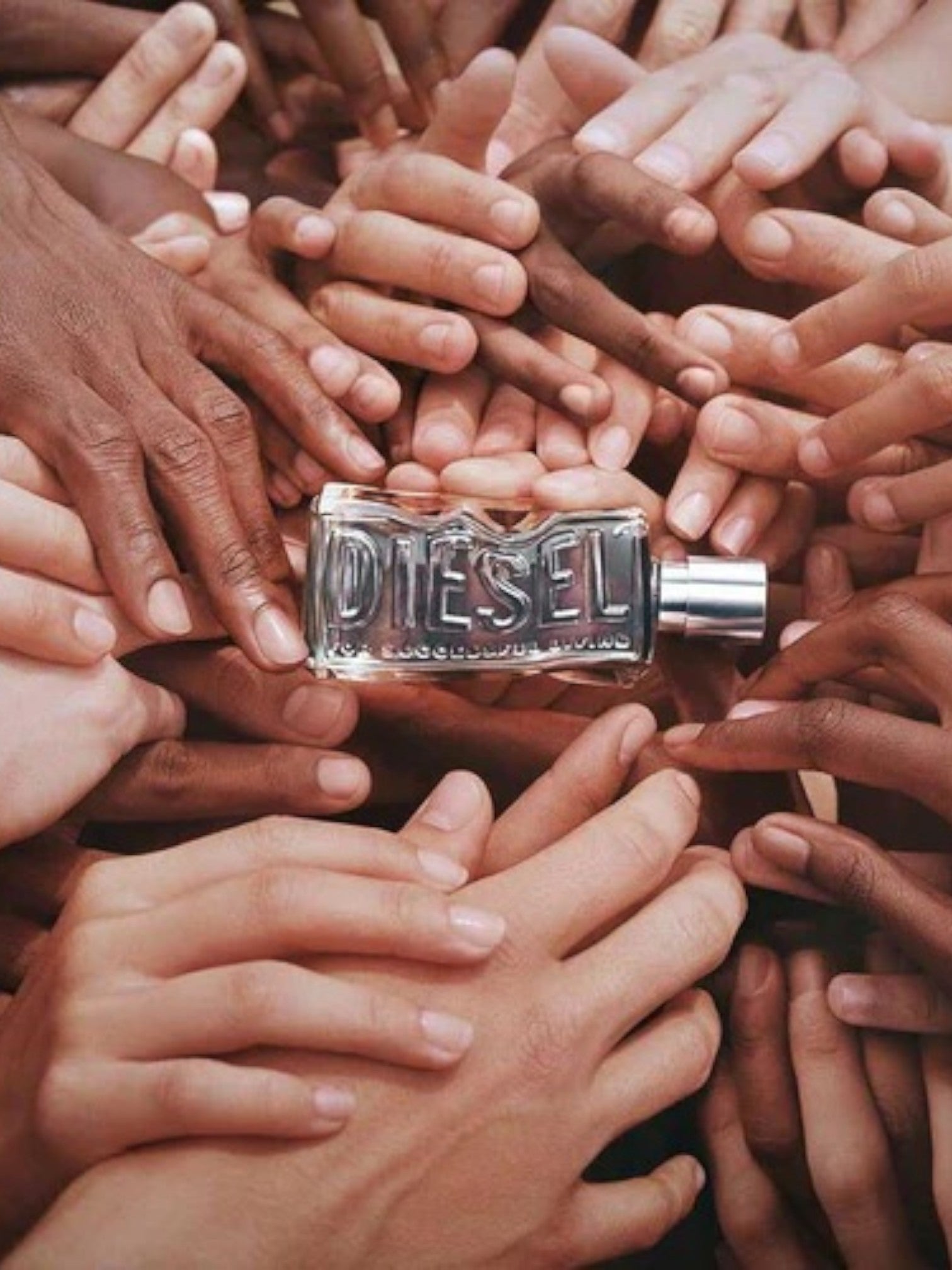 Diesel perfume bottle surrounded by hands of various skin tones monza outlet, Shein outlet, monza fashion