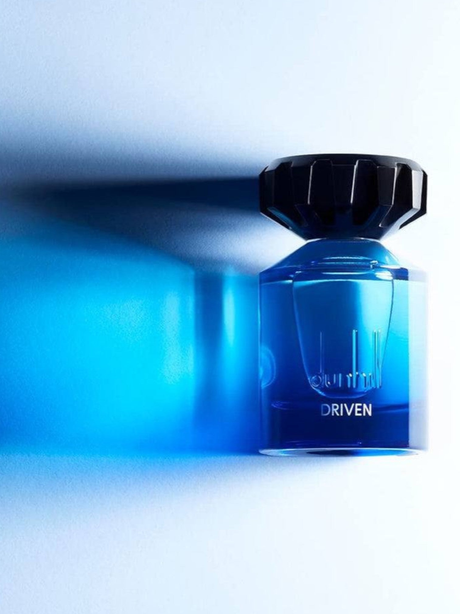 Blue perfume bottle with 'Driven' text on a white background. Dunhill, Monza Outlet, Monza Fashion, Shein Outlet 