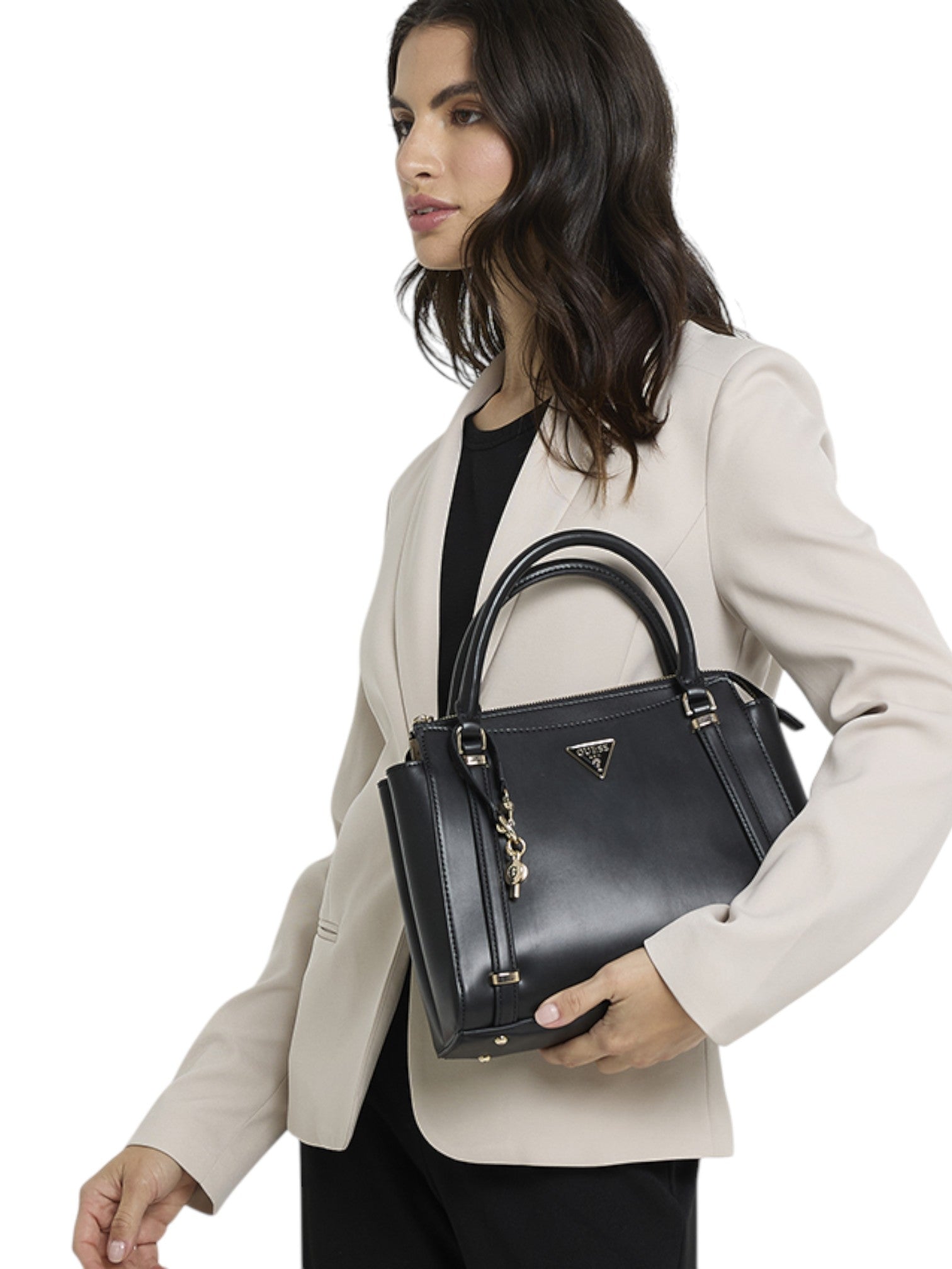 Woman holding a black handbag against a white background. Guess, Monza Outlet, Monza Fashion, Shein Outlet