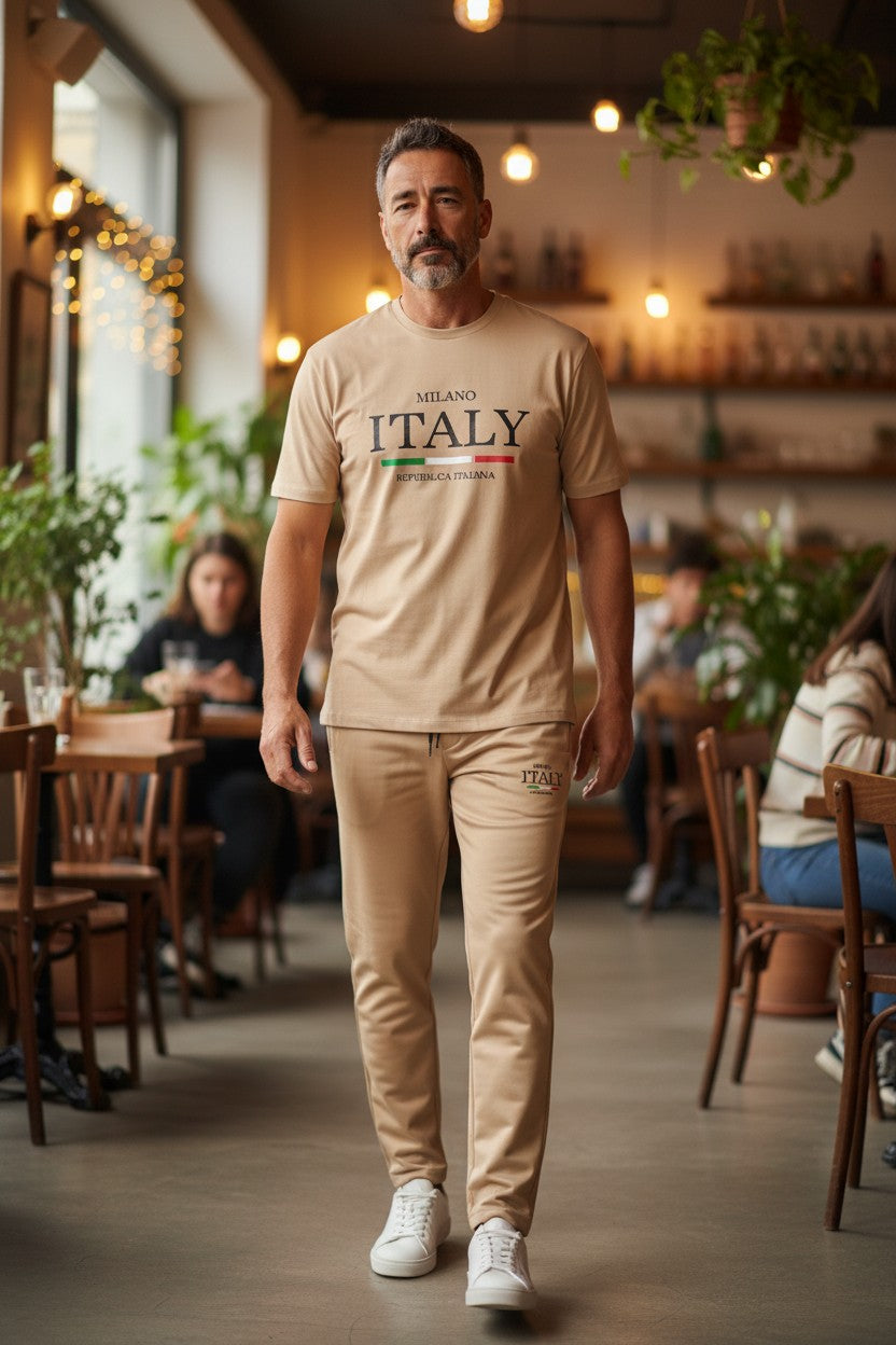 Man wearing a beige t-shirt with Milano Italy text in a restaurant setting. Antler, Monza Outlet, Monza Fashion, Shein Outlet