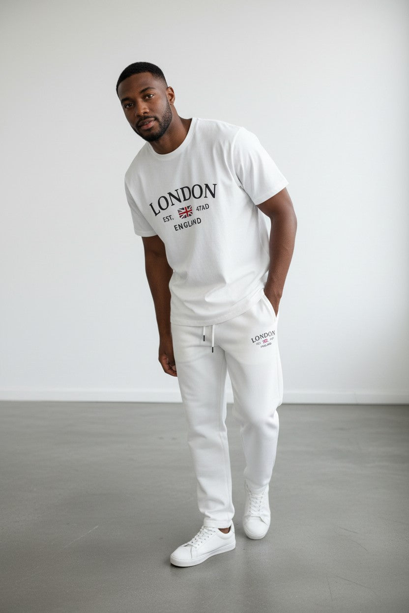Man wearing a white London England t-shirt and pants against a plain background. Antler, Monza Outlet, Monza Fashion, Shein Outlet