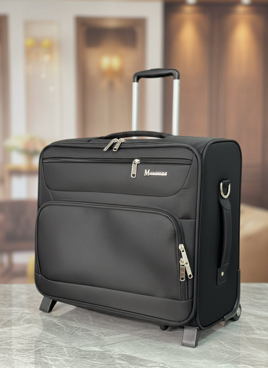 Black suitcase with a visible brand logo on a blurred indoor background. Monza Italy, Monza Outlet, Monza Fashion, Shein Outlet