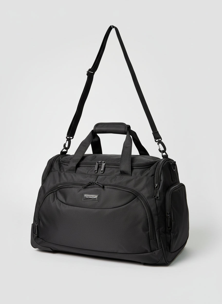 Black duffel bag with a strap on a light gray background. Monza Italy, Monza Outlet, Monza Fashion, Shein Outlet 