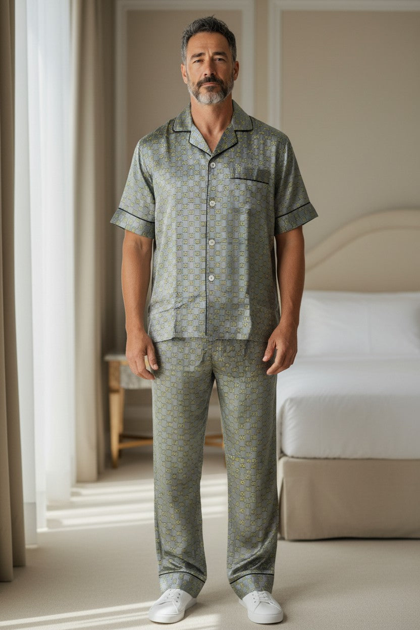 Man wearing a green patterned pajama set in a bedroom. Monza Italy, Monza Outlet, Monza Fashion, Shein Outlet