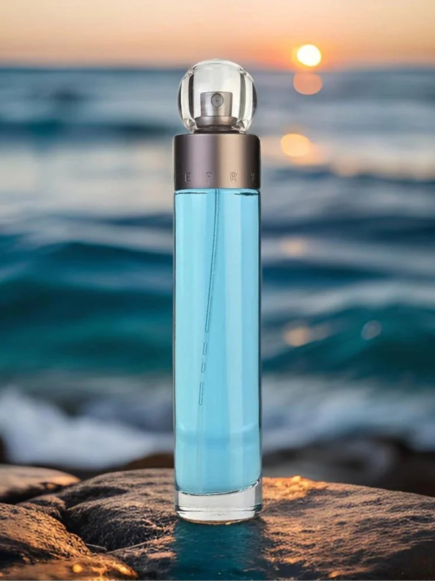 Perfume bottle with blue liquid on a rock by the ocean at sunset. Perry Ellis, Monza Outlet, Monza Fashion, Shein Outlet