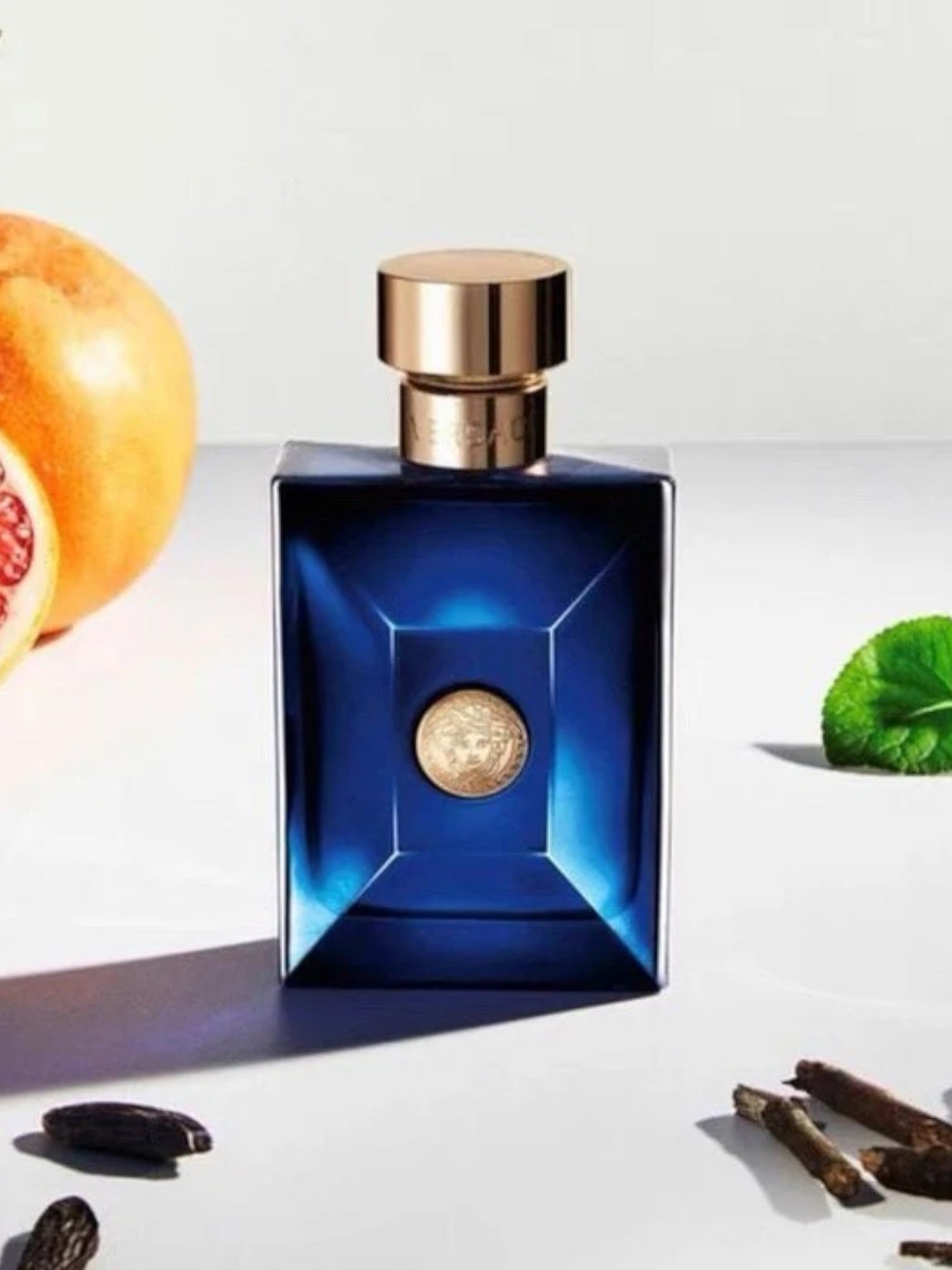 Blue perfume bottle with a gold cap on a white background. Versace, Monza Outlet, Monza Fashion, Shein Outlet