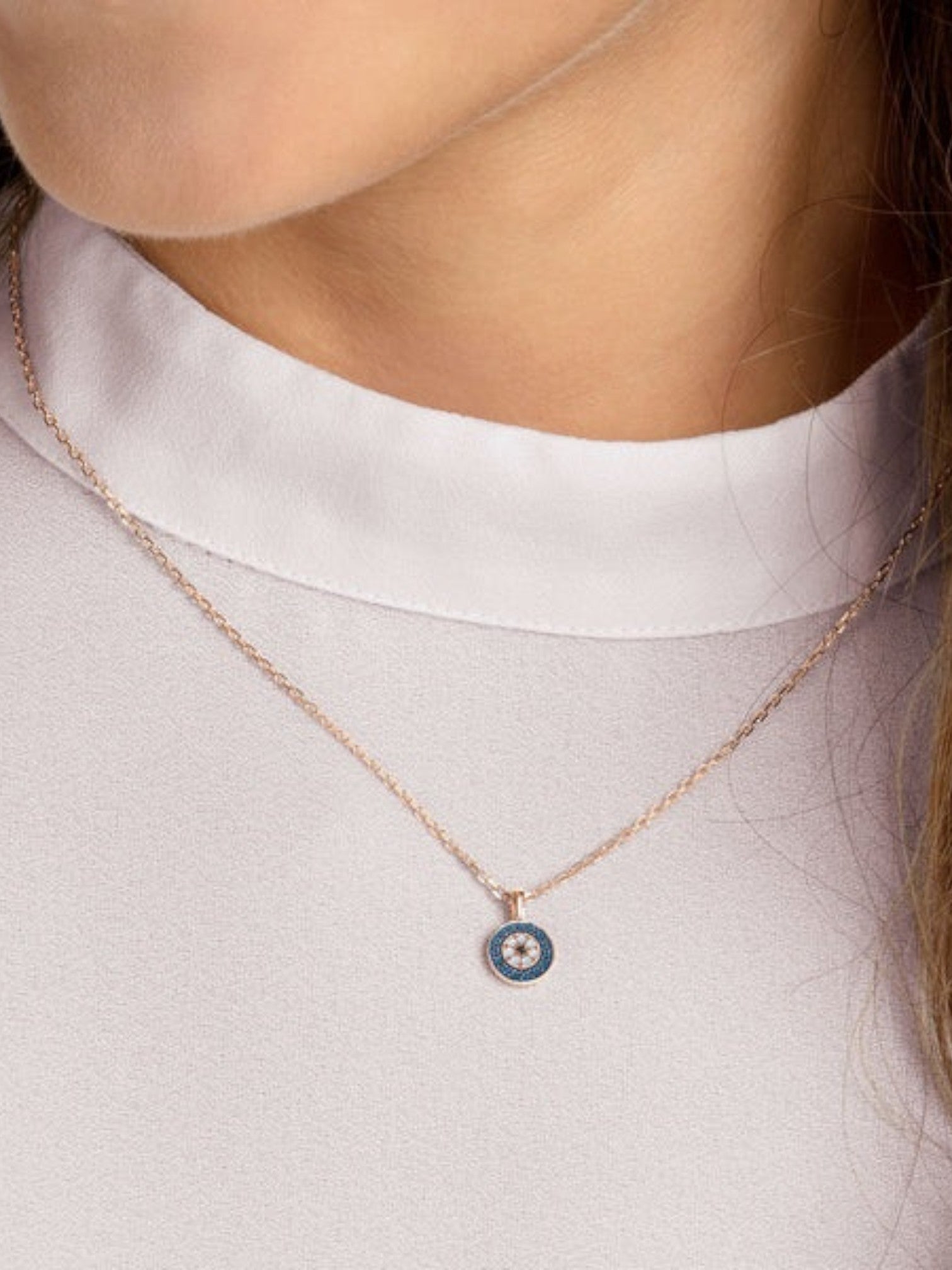 Necklace with a blue pendant worn by a person on a light background monza outlet, Shein outlet, monza fashion