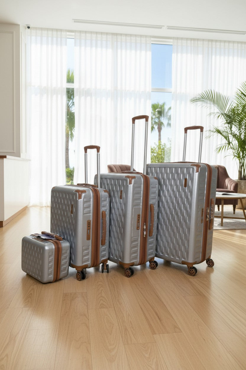 Set of silver suitcases with brown handles and wheels on a wooden floor. Monza Outlet, Monza Fashion, Shein Outlet