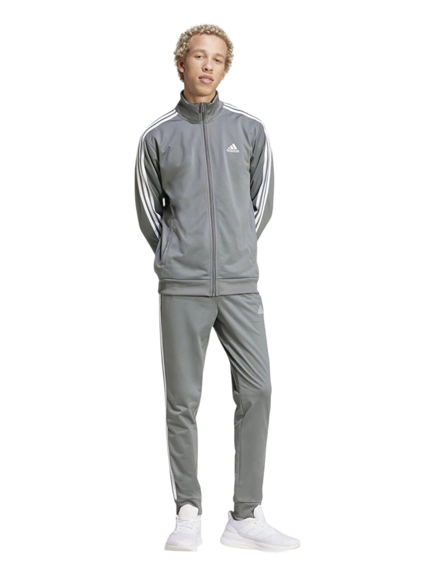 Person wearing a gray Adidas tracksuit on a white background. Adidas, Monza Outlet, Monza Fashion, Shein Outlet
