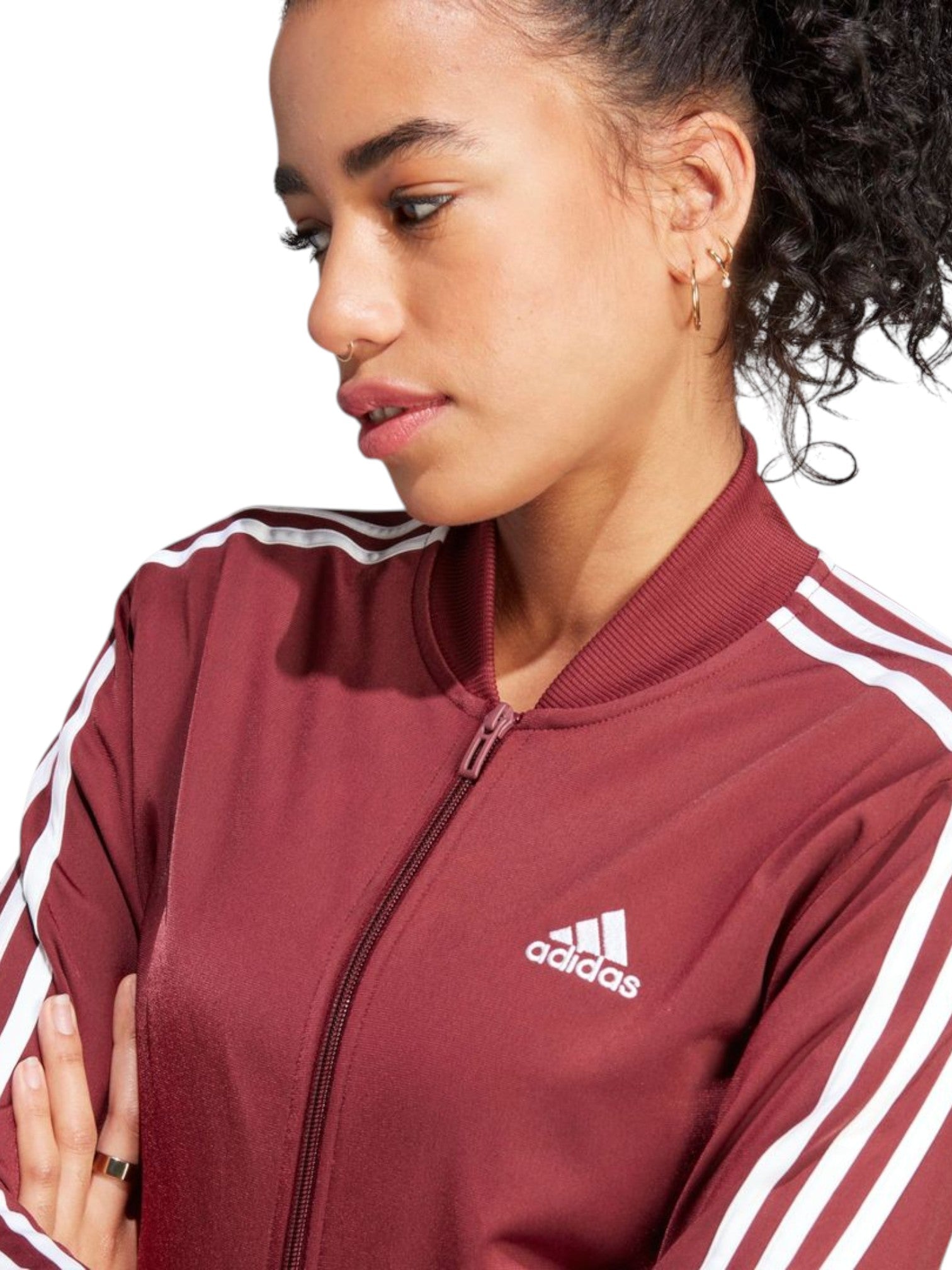 Person wearing a maroon Adidas jacket with white stripes on a white background. Adidas, Monza Outlet, Monza Fashion, Shein Outlet