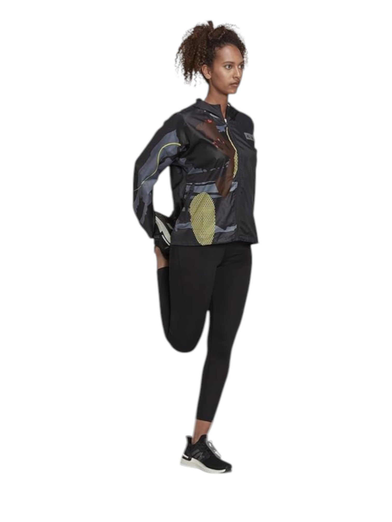 Woman wearing a black and gray patterned jacket with black leggings on a white background. Adidas, Monza Outlet, Monza Fashion, Shein Outlet