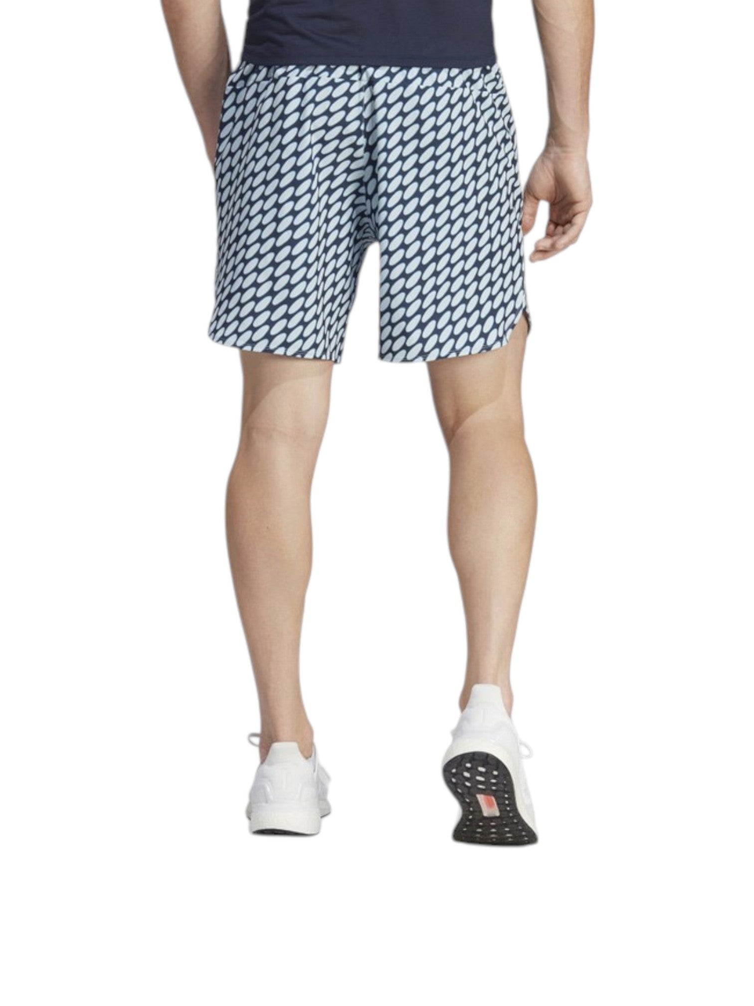 Person wearing patterned shorts on a white background. Adidas, Monza Outlet, Monza Fashion, Shein Outlet