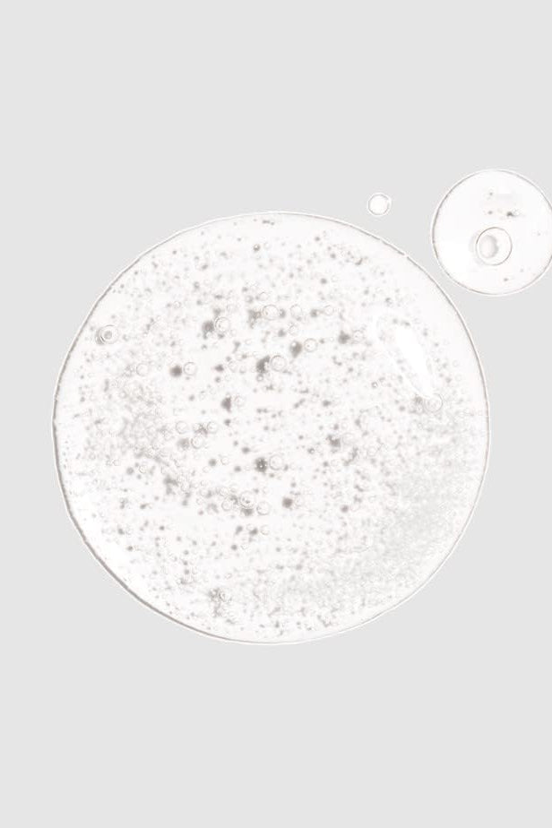 Close-up of a white powder with a magnified detail on a gray background Monza fashion outlet, monza outlet, shein outlet, shien outlet cosmetics, makeup, perfume