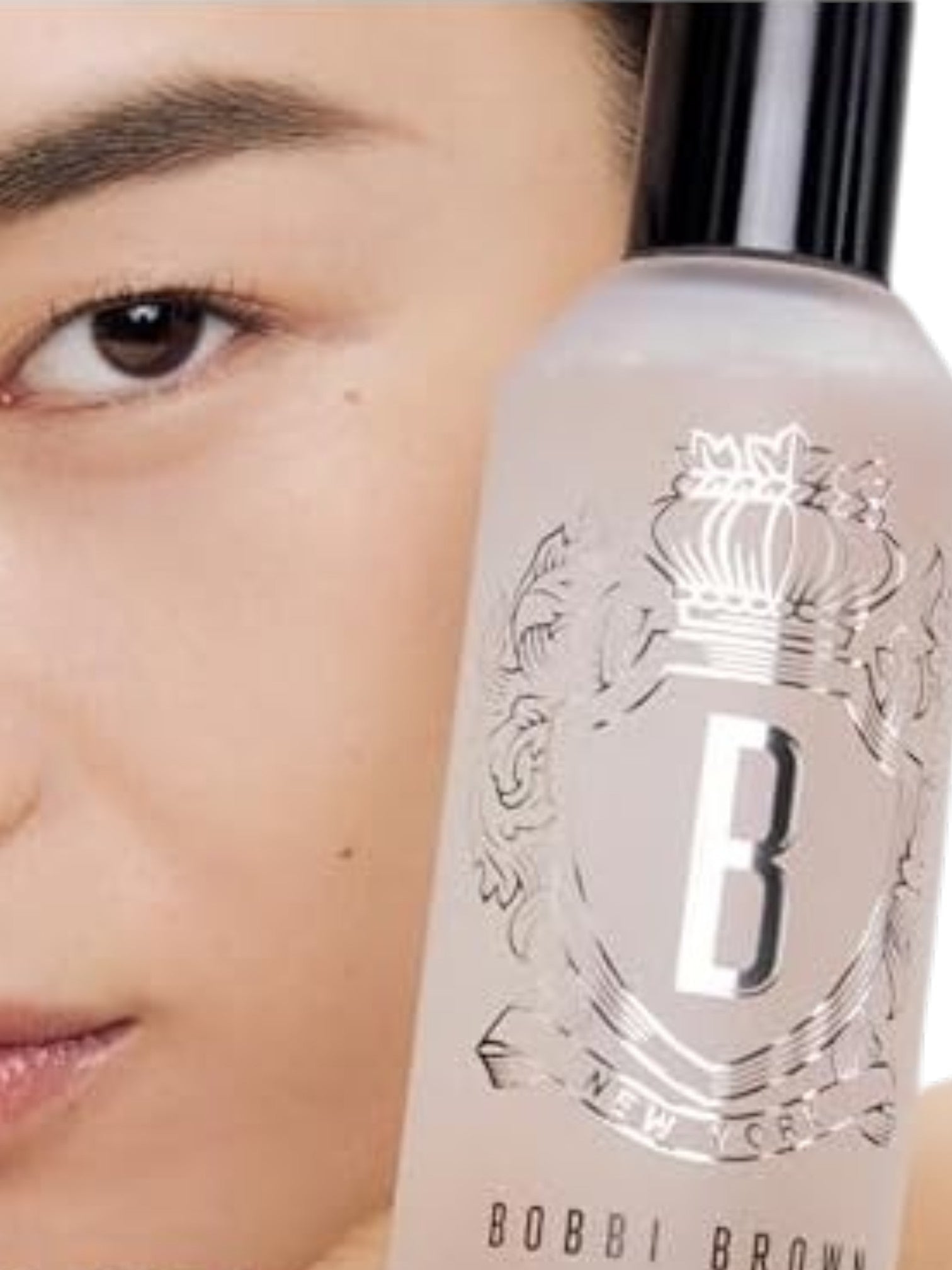 Bobbi Brown skincare bottle with a close-up of a person's eye in the background. Bobbi Brown, Monza Outlet, Monza Fashion, Shein Outlet