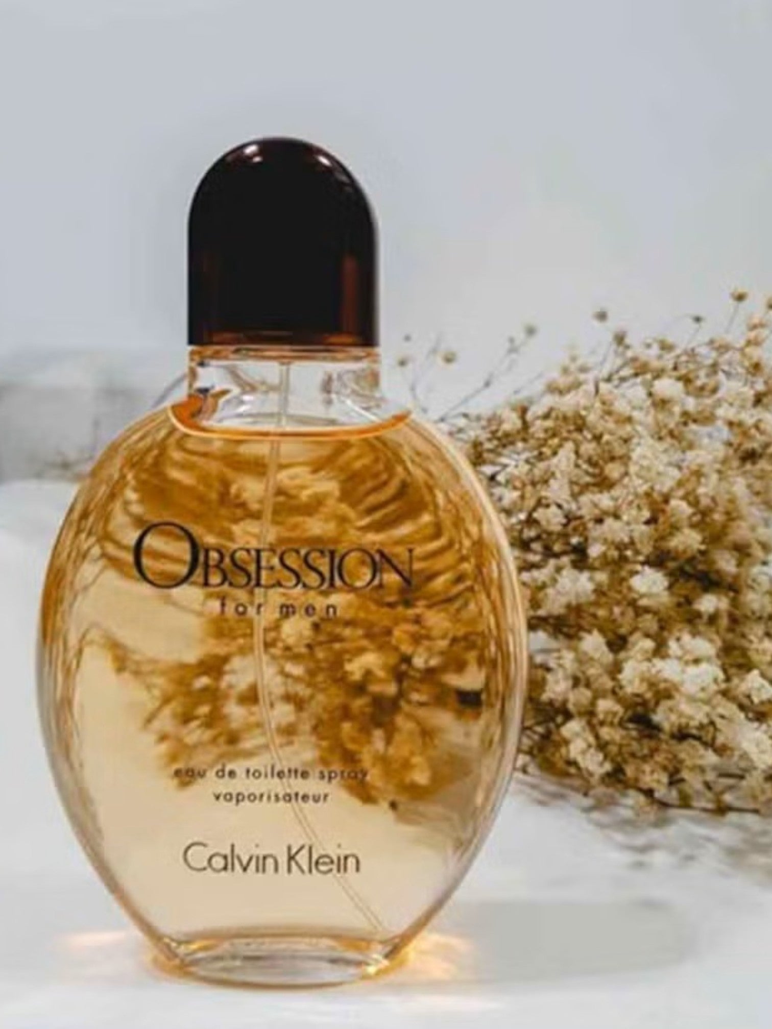 Calvin Klein Obsession for men perfume bottle with a blurred background monza outlet, Shein outlet, monza fashion