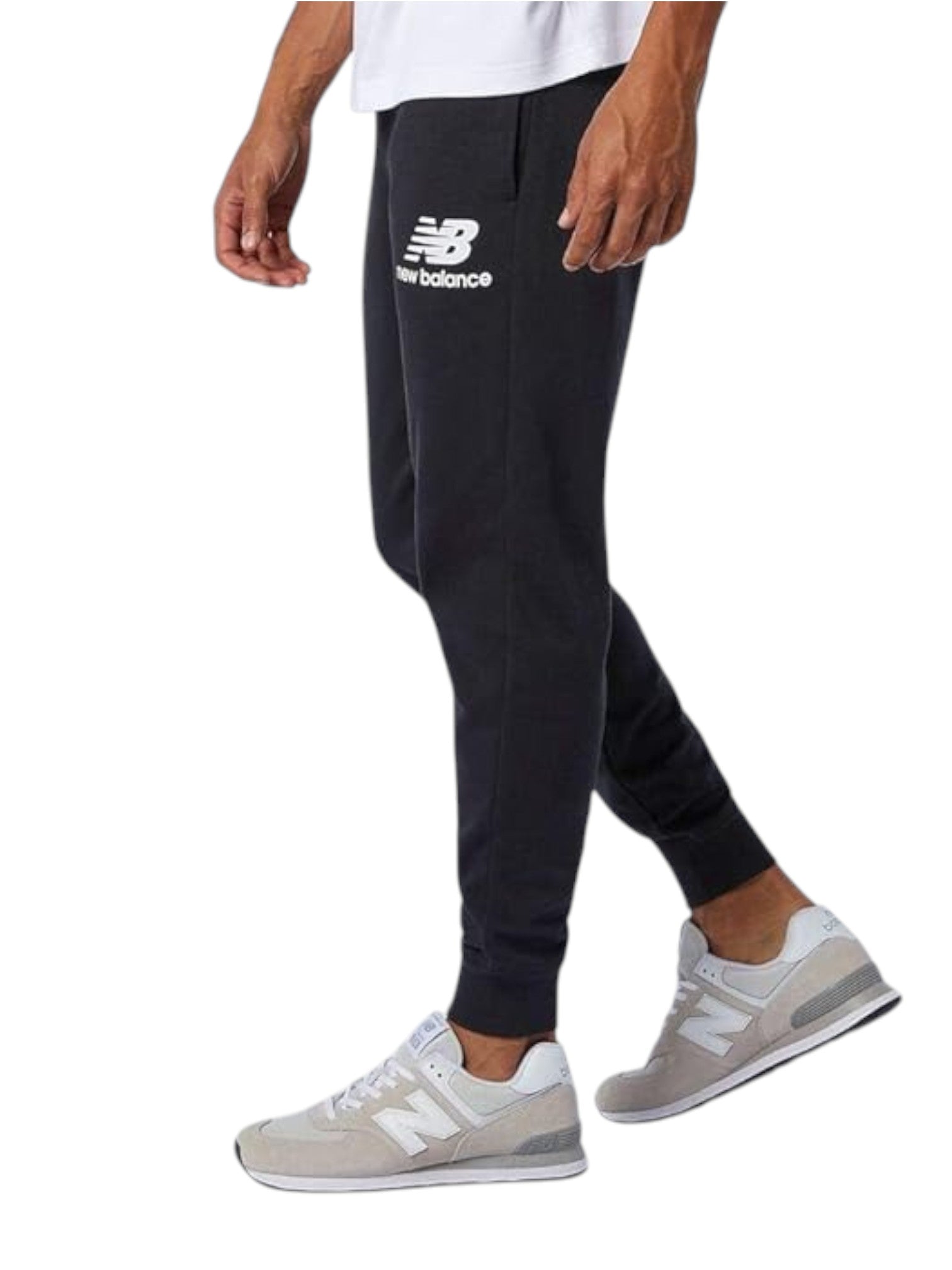 Person wearing black New Balance sweatpants and white sneakers on a white background. New Balance, Monza Outlet, Monza Fashion, Shein Outlet