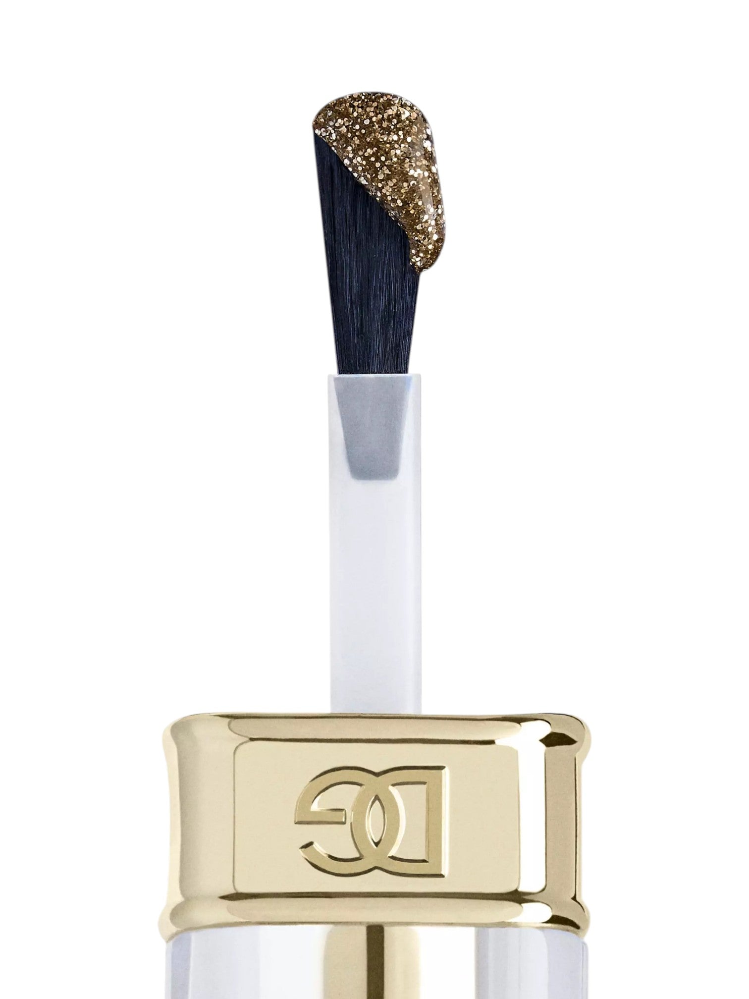 A close up of a cosmetic applicator brush with a gold glitter coated tip and a dark navy bristle base, attached to a white and gold tube with a prominent gold cap featuring an embossed monogram logo, on a white background. Dolce and Gabanna, Monza Outlet, Monza Fashion, Shein Outlet